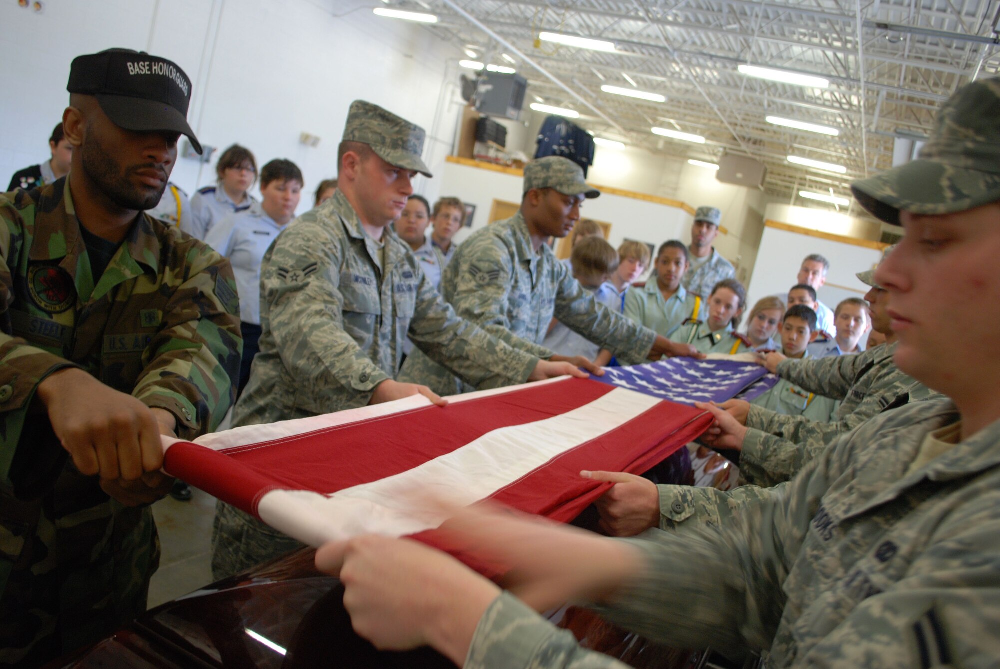 Members of the McConnell’s Honor Guard demonstrate a six-man flag fold for Junior Reserve Officer Training Corps cadets from Wichita public middle schools during a base orientation April 14, 2010, McConnell Air Force Base, Kan. In addition to the honor guard, the students toured a KC-135 Stratotanker, processed through a mobility line, visited the base dormitories and viewed instructional equipment at the medical group. The orientation provided the cadets a first-hand look at day-to-day military operations. (U.S. Air Force photo/2nd Lt. Nicholas Mercurio)