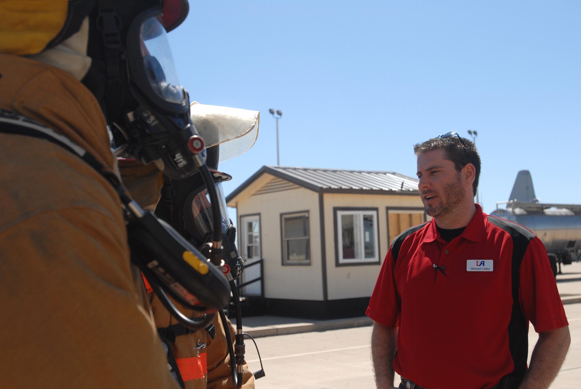 GOODFELLOW AIR FORCE BASE— Michael Collier, a Leadership San Angelo member chats with two fire fighter students during a tour of the Louis F. Garland Department of Defense Fire Academy, April 8. He is with more than 30 other Chamber of Commerce members, who are visiting the base to gain a better understanding of how Goodfellow affects the local community and economy. (U.S. Air Force photo/ Senior Airman Tong Duong)