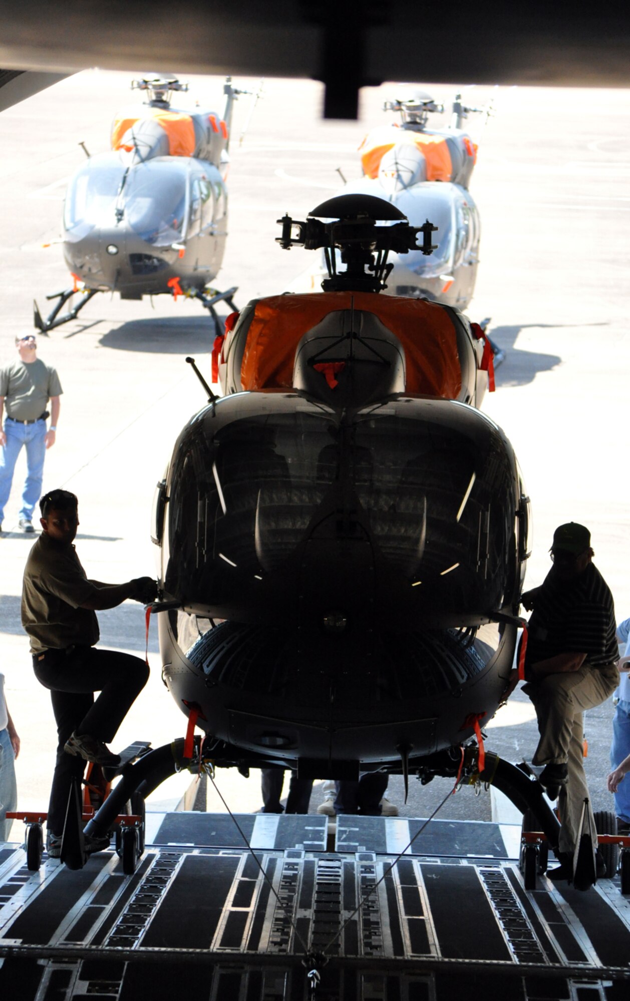 Representatives from American Eurocopter, Columbus, Miss., ride a UH-72 Lakota into the hold of a C-17 April 12. The Army’s new light utility helicopters are manufactured by American Eurocopter and were transported by C-17 to Germany. (U.S. Air Force photo/Senior Airman Jacob Corbin). 