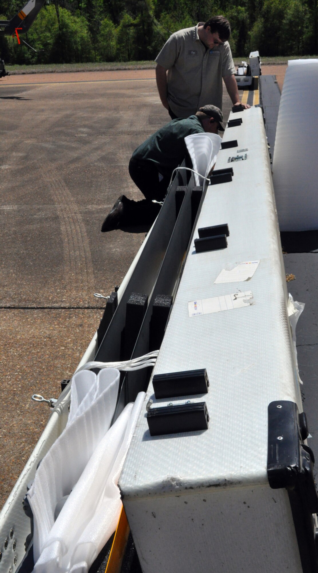 James Wagner and Terry Teer help pack UH-72 Lakota helicopter blades for transport from Columbus AFB, Miss., to Germany, April 9. Mr. Wagner and Mr. Teer are employees of American Eurocopter, Columbus, Miss., the manufacturer of the UH-72 Lakota. (U.S. Air Force photo/Senior Airman Jacob Corbin). 