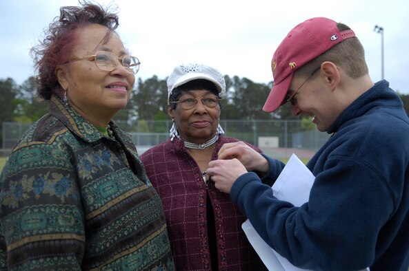 Dezretta Jackson, Lillington Resident, 73 (left) and Ruth Frederick, Lillington Resident, 73, receive a 1500-kilometer Race Walk participation ribbon from Brian Gaskill, volunteer at the 2010 Mid Carolina Senior Games held at the Pope Fitness Center on April 14. Pope has hosted the event for 26 years. (U.S. Air Force Photo/ 2nd Lt. Cammie Quinn)