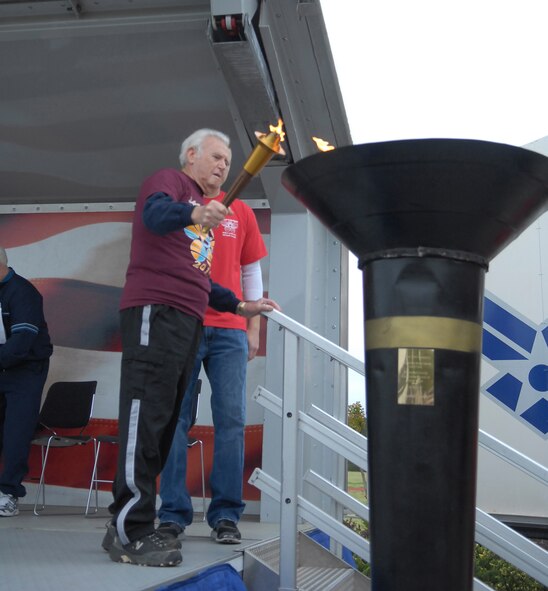 Reece Cain, Fayetteville Resident,80, ignites the Olympic torch, designating the opening of the 26th Annual Mid Carolina Senior Games at the Pope Fitness Center on April 14. The Senior Games is a wellness a prevention program to keep the senior citizens’ bodies, minds and spirits fit while in the company of friends, family, spectators and volunteers. Pope has hosted the event for 26 years. (U.S. Air Force photo/2nd Lt. Cammie Quinn)