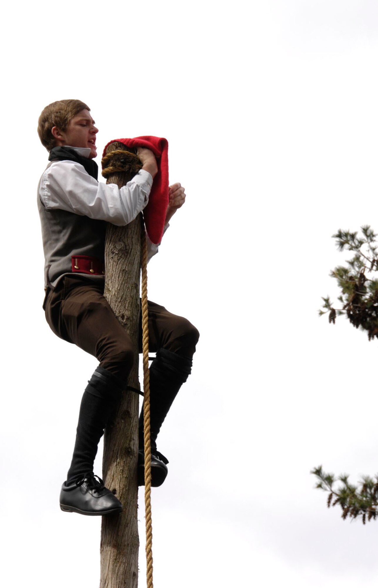 BEDFORD, Mass. – A reenactor climbs the liberty pole and declares liberty during the annual Bedford Pole Capping event on April 10. In honor of Patriot’s Day and the beginning of the Revolutionary War, many surrounding towns hold events leading up to April 19. (U.S. Air Force photo by Linda LaBonte Britt)