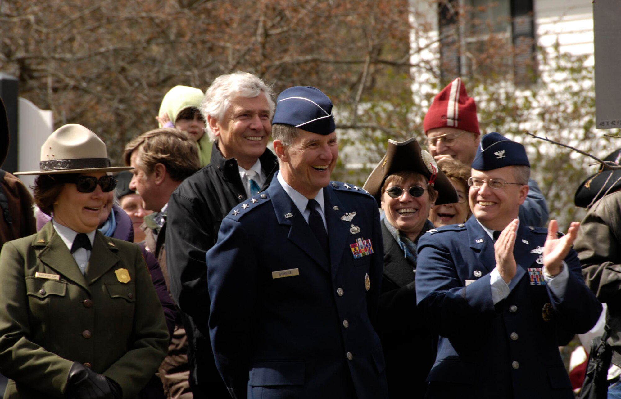 BEDFORD, Mass. – Lt. Gen. Ted F. Bowlds (middle), Electronic Systems Center commander, and Col. Charles F. Thompson (right), 66th Air Base Wing commander, laugh at some of the humorous reenactments during the Bedford Pole Capping event on April 10. General Bowlds and Colonel Thompson served as part of the parade reviewing committee during the event leading up to Patriot’s Day. (U.S. Air Force photo by Linda LaBonte Britt)