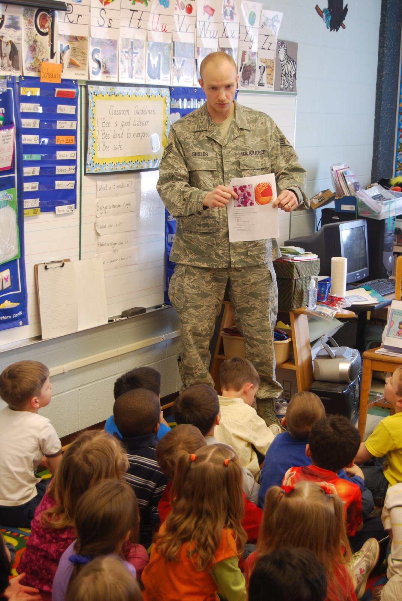 Staff Sgt. Jonathan Shields, a laboratory technician with the 341st Medical Support Squadron, talks with kindergarten students at Loy Elementary School about the different kind of germs that they could carry on their hands during a follow-up visit with the children April 1. (U.S. Air Force photo/Airman 1st Class Kristina Overton)
