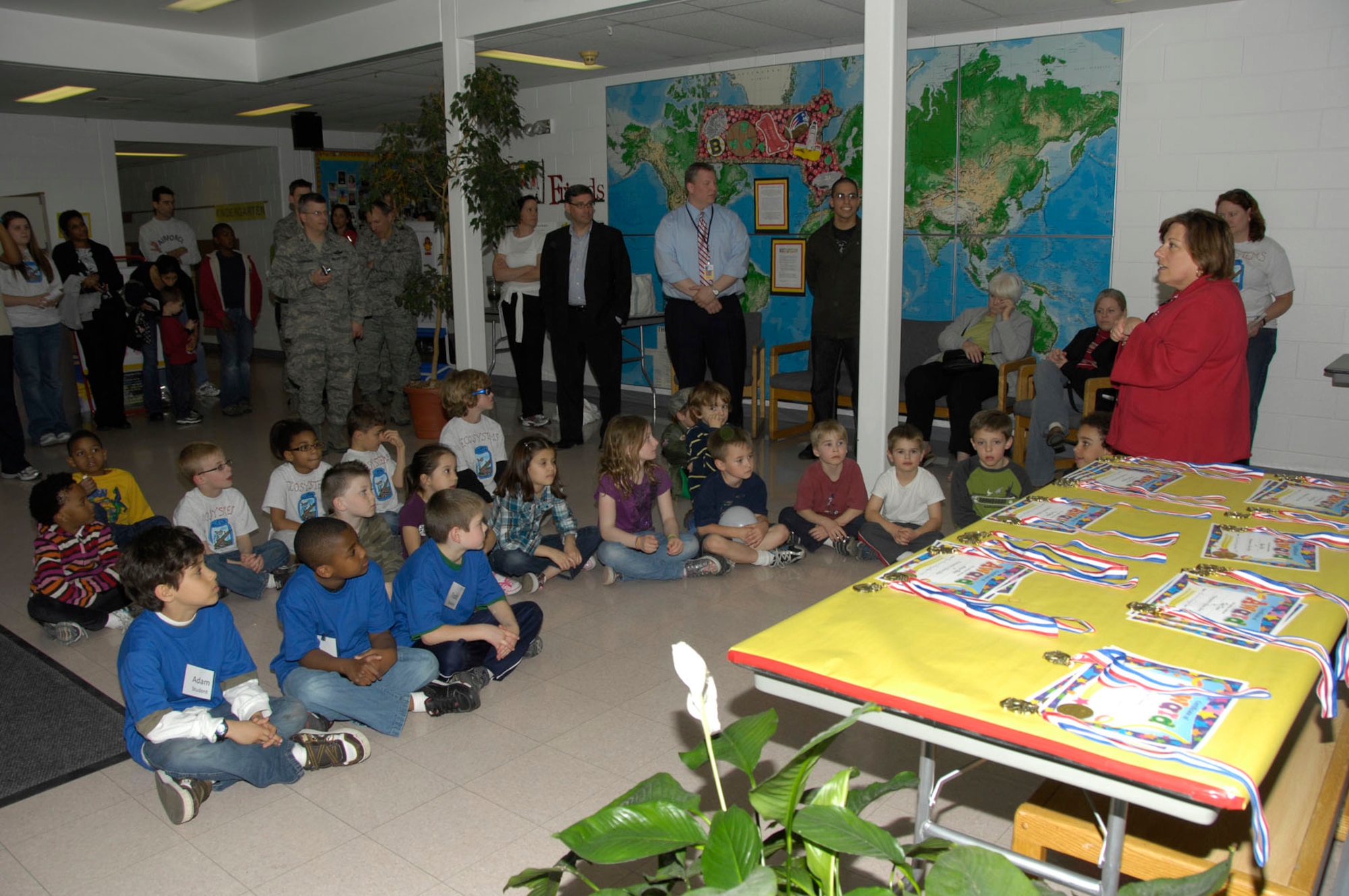HANSCOM AIR FORCE BASE, Mass. – Participants, volunteer coaches and base personnel gather around after the Hanscom Primary School’s non-competitive K-4 Science Share Fair on April 13. Students worked with volunteer coaches from the base to learn and discover new science topics through lessons, books and experiments. (U.S. Air Force photo by Linda LaBonte Britt)