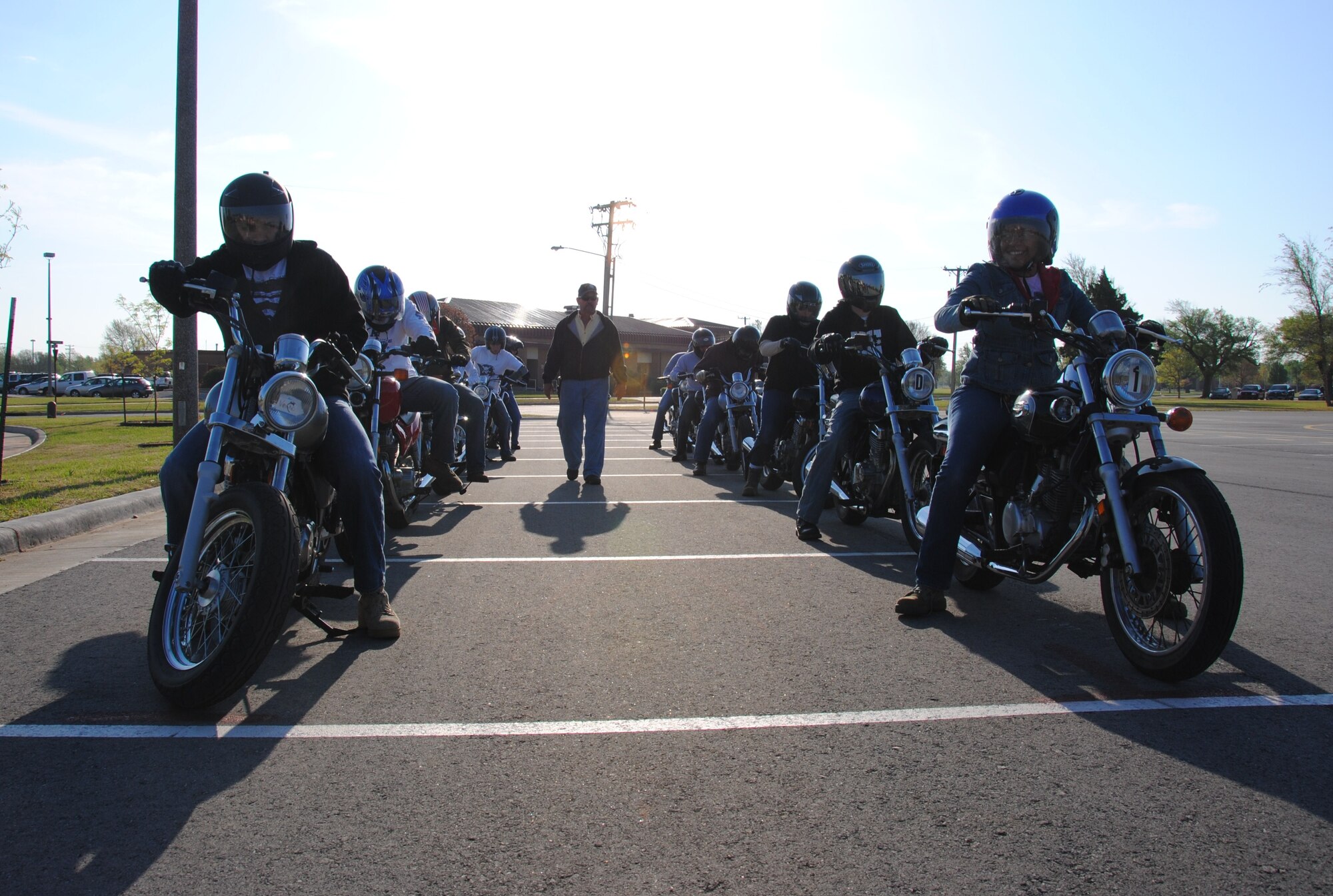 Motorcycle riding coach, Bill Dimsdale, instructs 12 students enrolled in the basic rider course offered by the Vance Safety office April 15. The three rider coaches, including Ryan Boyer and Wayne Smith, are each volunteers for the Oklahoma Riders Education Program based out of Oklahoma City. This course or a similar course is a requirement for all Active Duty members wanting to ride a motorcycle on and off base.  (U.S. Air Force photo/ 2nd Lt. Christopher L. Buzzetta)