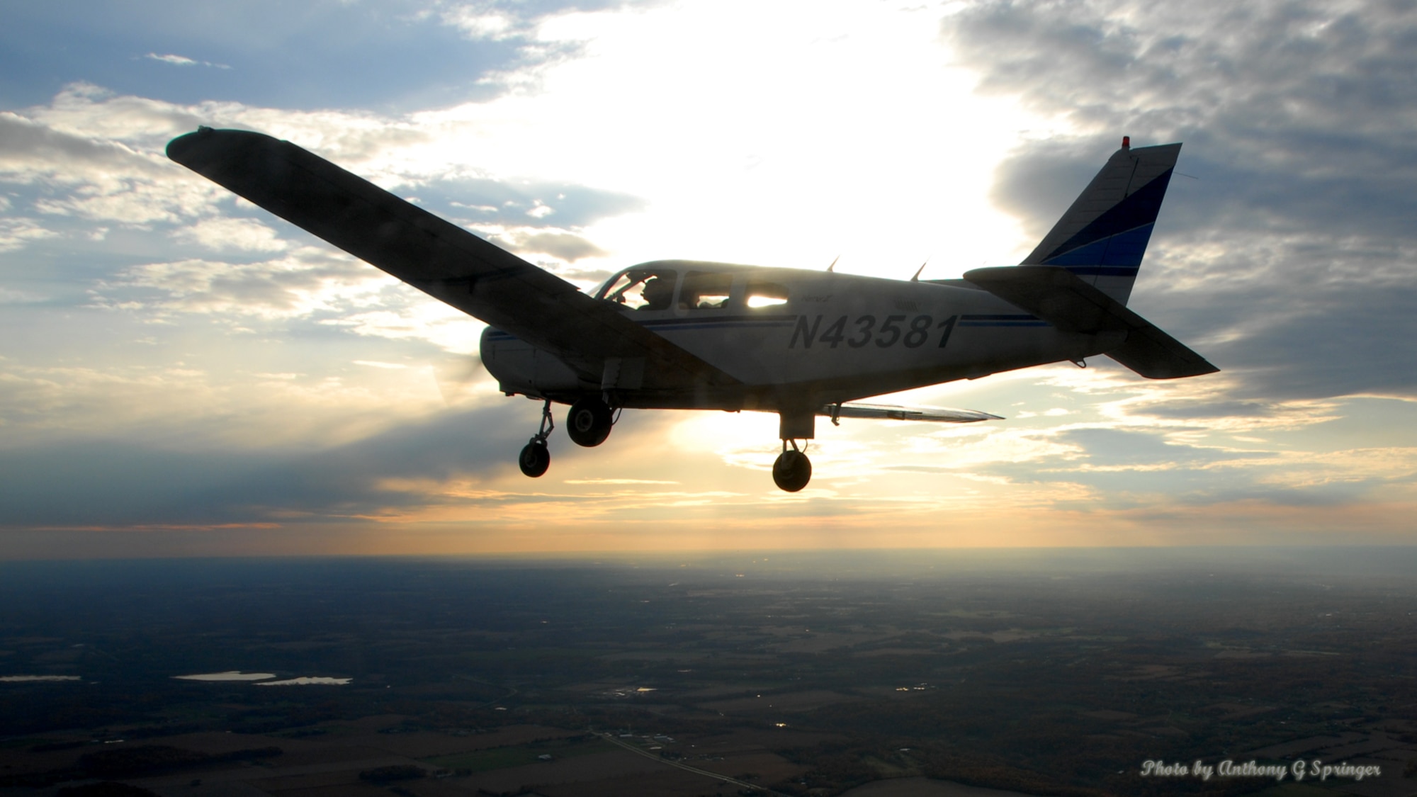 Steve "Hobo" Miller and Terry "Ski" Slawinski fly over Greene County during a four ship formation practice as the sun descends toward the horizon on October 15, 2009.