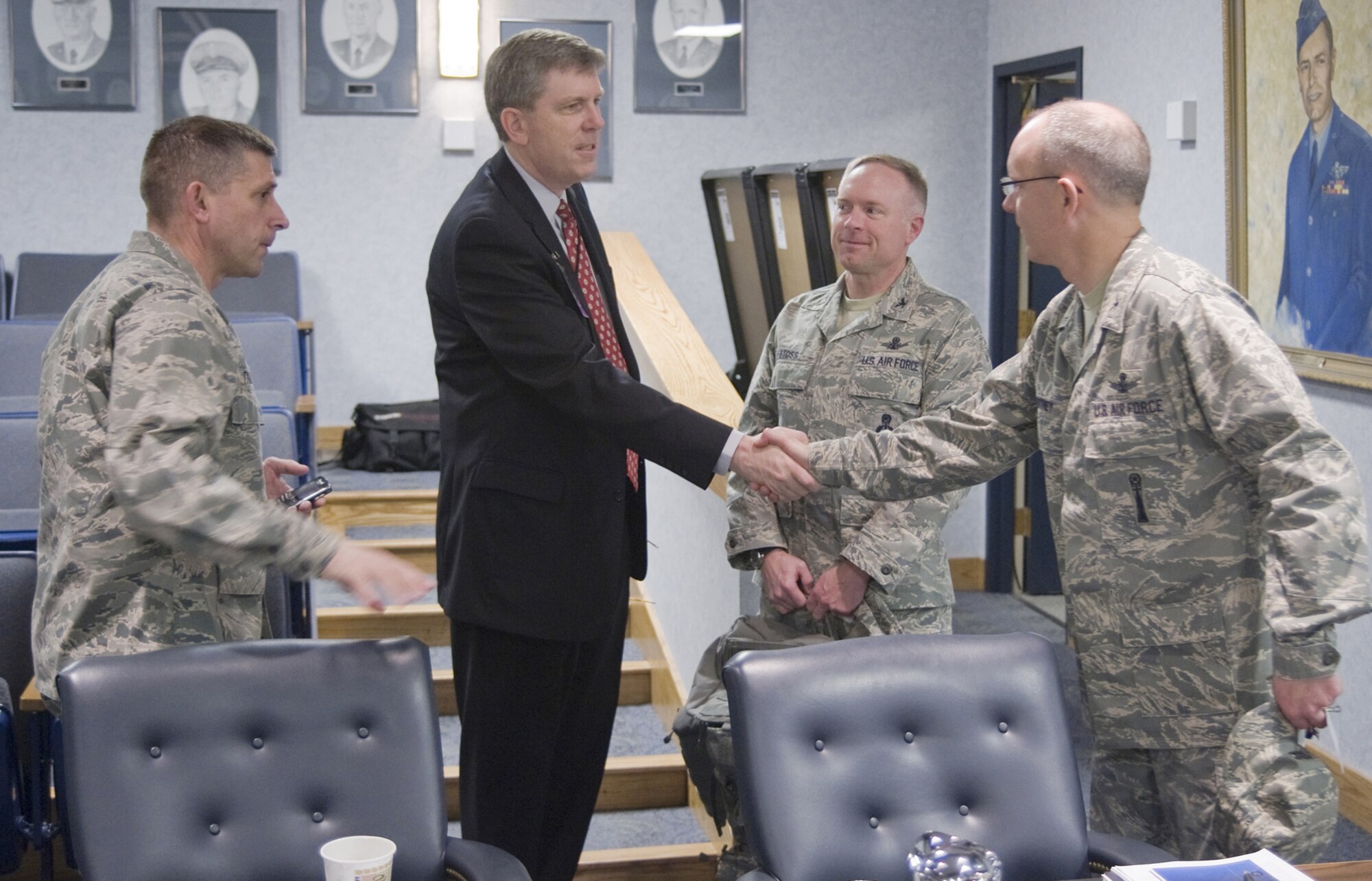 Col. Michael Fortney, 341st Missile Wing Commander, greets Mr. Mark Johnson, Executive Director of the Ogden Air Logistics Center, prior to the start of the inaugural ICBM Sustainment General Officer Steering Group meeting April 8. Col. Randy Tymofichuk, 309th Missile Maintenance Group commander (left) and Col. Ferdinand Stoss, 91st MW commander, listen in. (U.S. Air Force photo/Beau Wade)