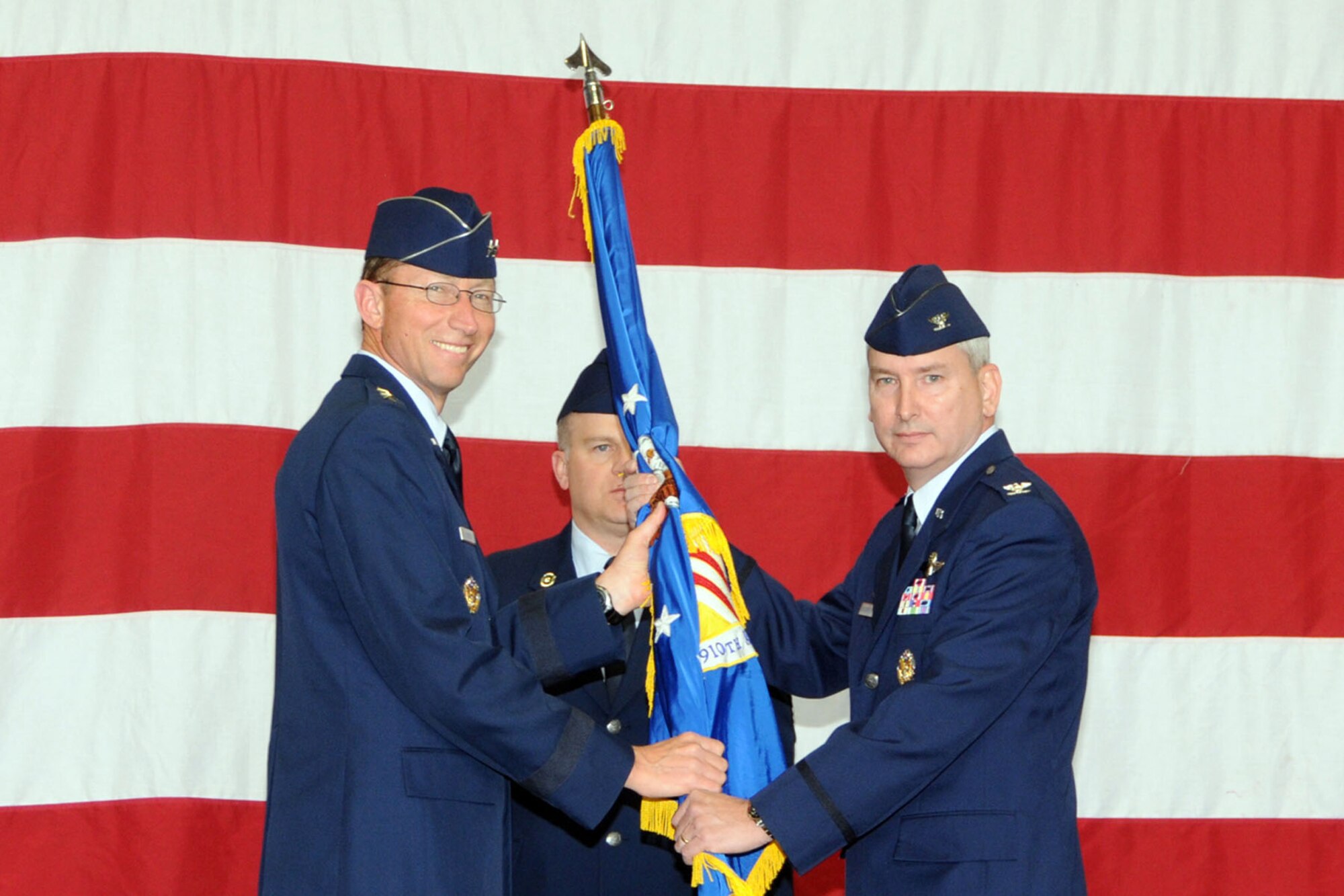 YOUNGSTOWN AIR RESERVE STATION, Ohio -- Air Force Reserve Maj. Gen. James T. Rubeor, commander of the 22nd Air Force, hands the guidon, or unit flag, of the 910th Airlift Wing to Col. Fritz Linsenmeyer during a wing change of command ceremony in a hangar here, April 11. Colonel Linsenmeyer assumed command of the wing from Col. Karl McGregor during the event. Colonel McGregor assumed command of the 452nd Air Mobility Wing at March Air Reserve Base, Calif., March 27. Colonel Linsenmeyer's previous assignment was commander of the 916th Air Refueling Wing, an Air Force Reserve unit at Seymour Johnson Air Force Base, NC. As commander of the 910th, Colonel Linsenmeyer is the leader of more than 1800 Citizen Airmen, Air Reserve Technicians and civil service employees and has operational control of 12 C-130H tactical cargo transport aircraft. U.S. Air Force photo by Tech. Sgt. James Brock.