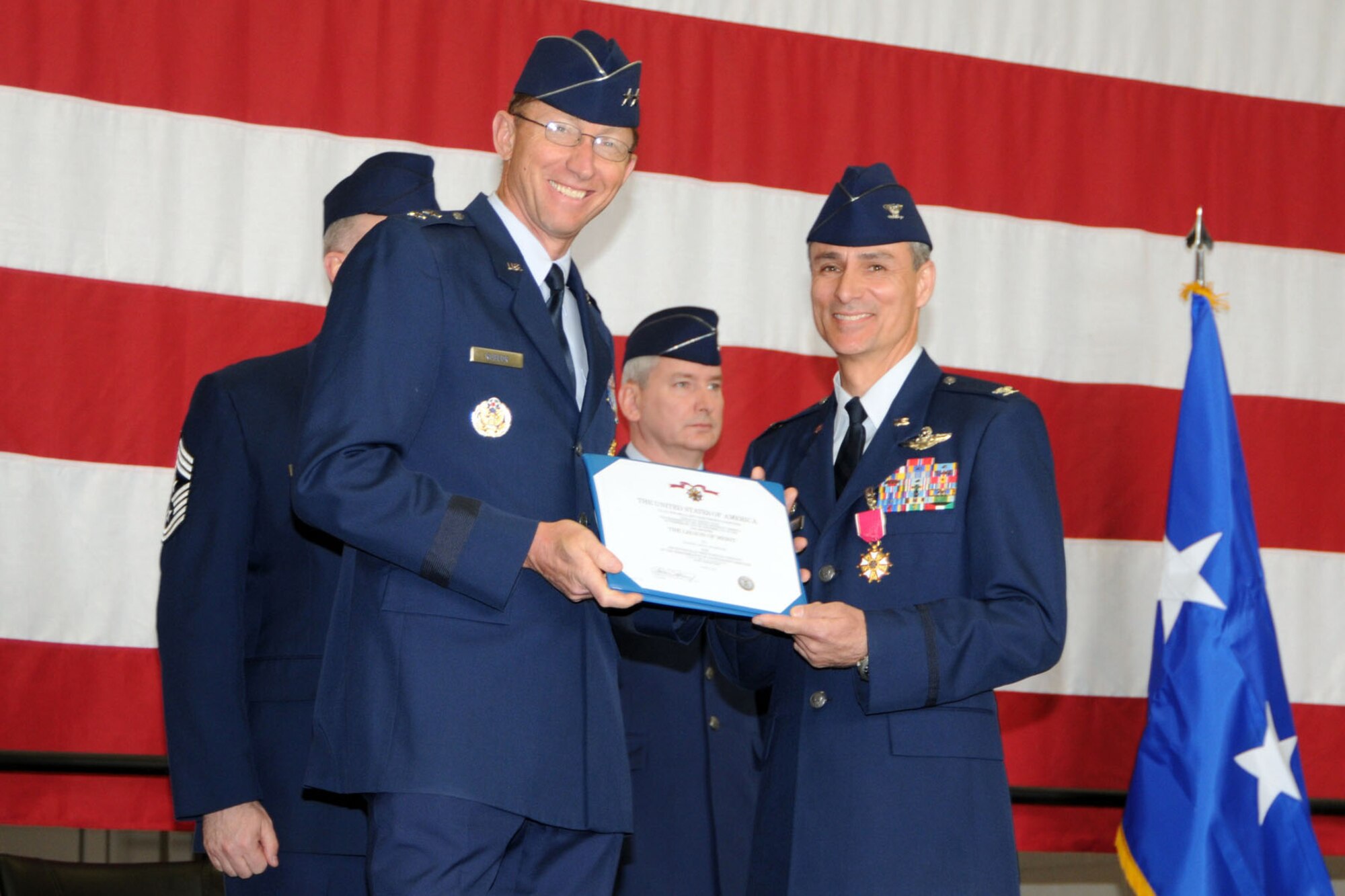 YOUNGSTOWN AIR RESERVE STATION, Ohio -- Air Force Reserve Maj. Gen. James T. Rubeor, commander of the 22nd Air Force, poses for a photo with Col. Karl McGregor shortly after awarding him the Legion of Merit during a wing change of command ceremony in a hangar here, April 11. Col. Fritz Linsenmeyer assumed command of the wing from Colonel McGregor during the event. Colonel McGregor assumed command of the 452nd Air Mobility Wing at March Air Reserve Base, Calif., March 27. Colonel Linsenmeyer's previous assignment was commander of the 916th Air Refueling Wing, an Air Force Reserve unit at Seymour Johnson Air Force Base, NC. As commander of the 910th, Colonel Linsenmeyer is the leader of more than 1800 Citizen Airmen, Air Reserve Technicians and civil service employees and has operational control of 12 C-130H tactical cargo transport aircraft. U.S. Air Force photo by Tech. Sgt. James Brock.