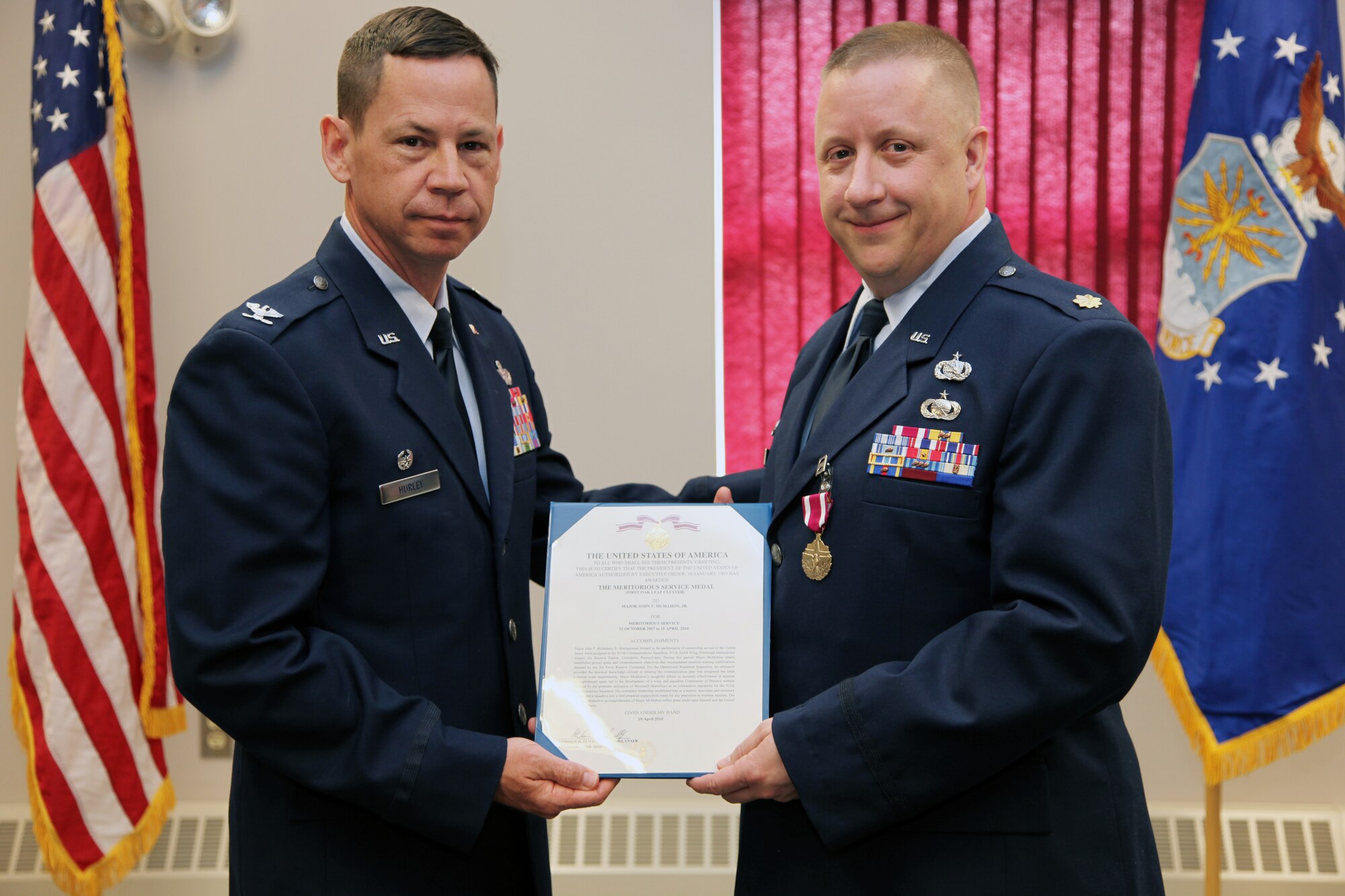 PITTSBURGH IAP/ARS, PA. -- (11 Apr 10) -- Col James B. Hurley, 911th Mission Support Group commander,  presents Maj John T. McMahon, Jr. with the Meritorious Service Medal for his service as the, now former, 911th Communications Squadron commander.  