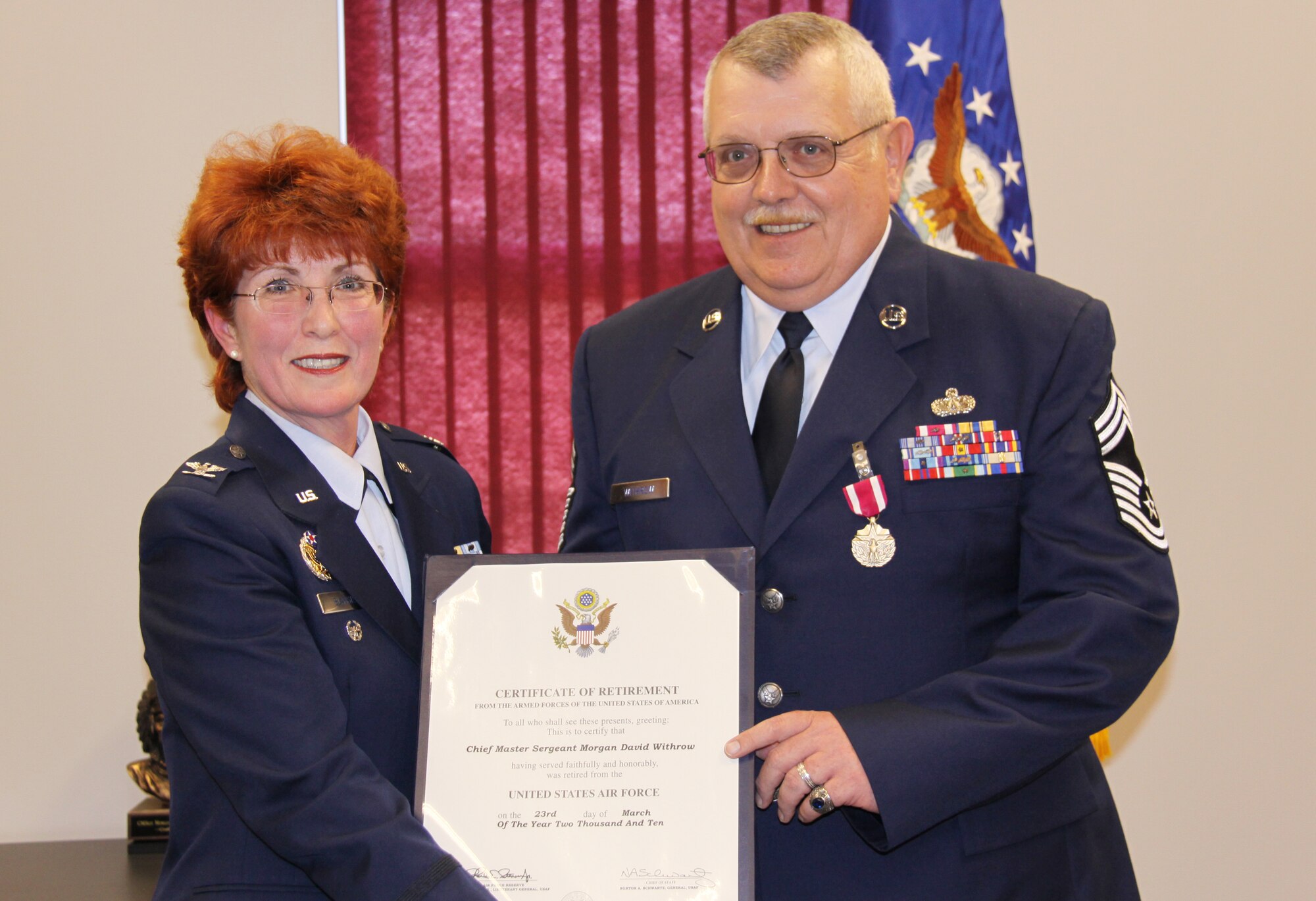 PITTSBURGH IAP/ARS, PA. -- (10 Apr 10) -- Chief Master Sgt. Morgan D Withrow, 911th Civil Engineering Squadron, is presented with his certificate of retirement on April 10 by Col. Patricia S Blassie. Chief Withrow first enlisted in 1974 and has received a vast number of major awards and decorations.  Colonel Blassie, former 911th Mission Support Group commander, is currently the executive officer to Lt. General Charles E Stenner, Air Force Reserve Command commander.  (Photo by A1C Melissa Knox)