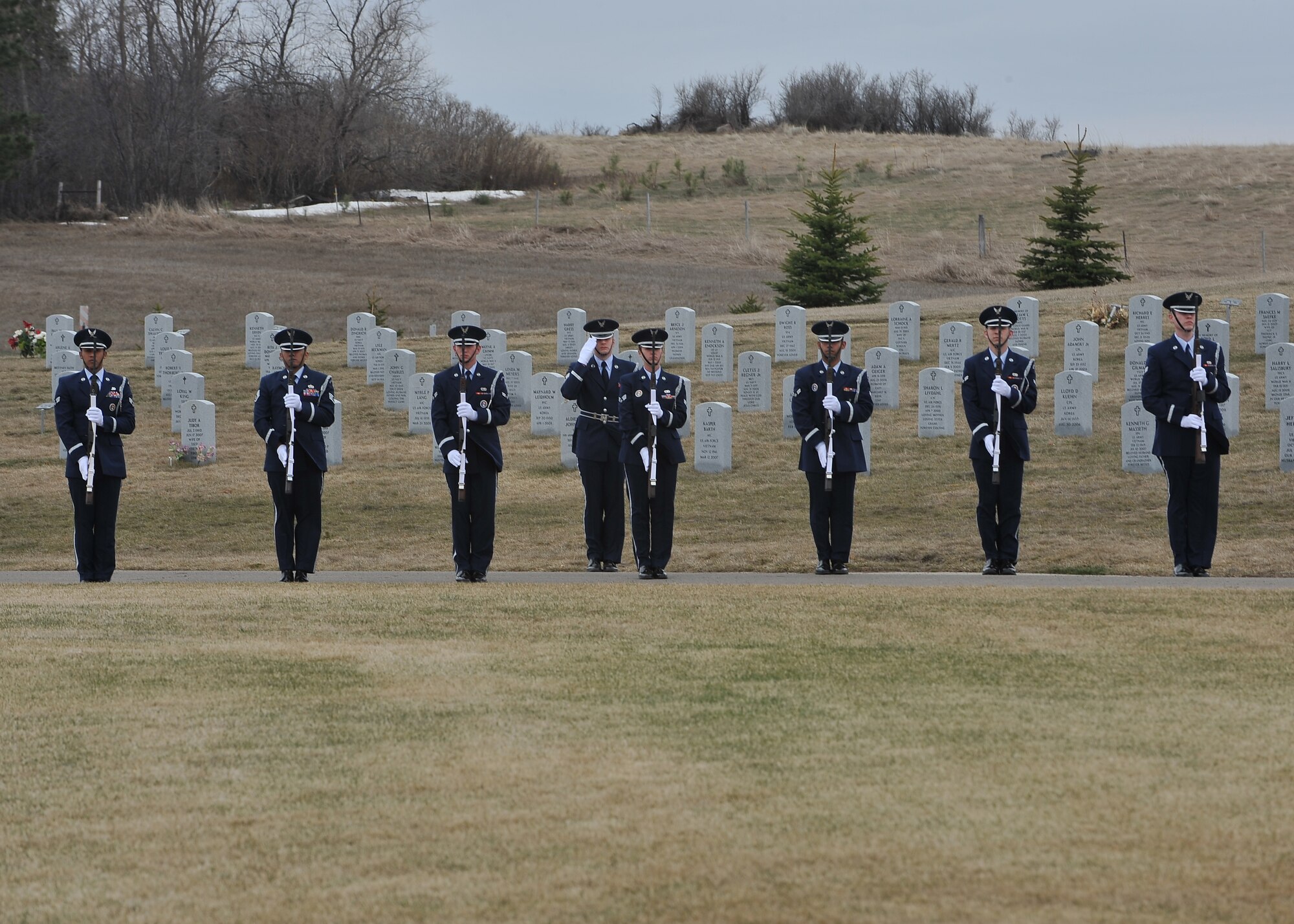 MANDAN, N.D. -- The Minot Air Force Base Honor Guard presents arms in honor of a fallen Airman at the North Dakota Veterans Cemetery in Mandan, N.D., April 12. The purpose of the base honor guard is to give honor to military members during a variety of ceremonies, including funerals. (U.S. Air Force photo by Senior Airman Ashley N. Avecilla)