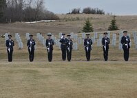 MANDAN, N.D. -- The Minot Air Force Base Honor Guard presents arms in honor of a fallen Airman at the North Dakota Veterans Cemetery in Mandan, N.D., April 12. The purpose of the base honor guard is to give honor to military members during a variety of ceremonies, including funerals. (U.S. Air Force photo by Senior Airman Ashley N. Avecilla)