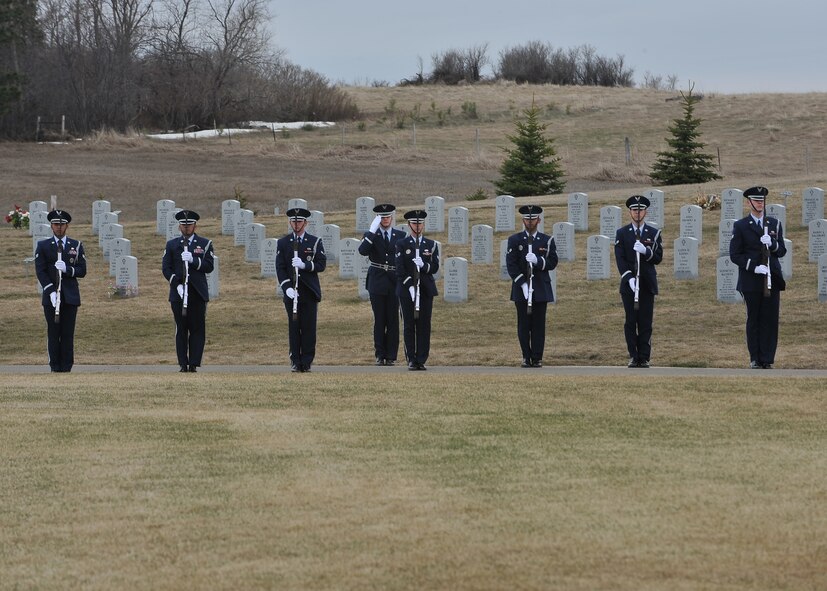 MANDAN, N.D. -- The Minot Air Force Base Honor Guard presents arms in honor of a fallen Airman at the North Dakota Veterans Cemetery in Mandan, N.D., April 12. The purpose of the base honor guard is to give honor to military members during a variety of ceremonies, including funerals. (U.S. Air Force photo by Senior Airman Ashley N. Avecilla)