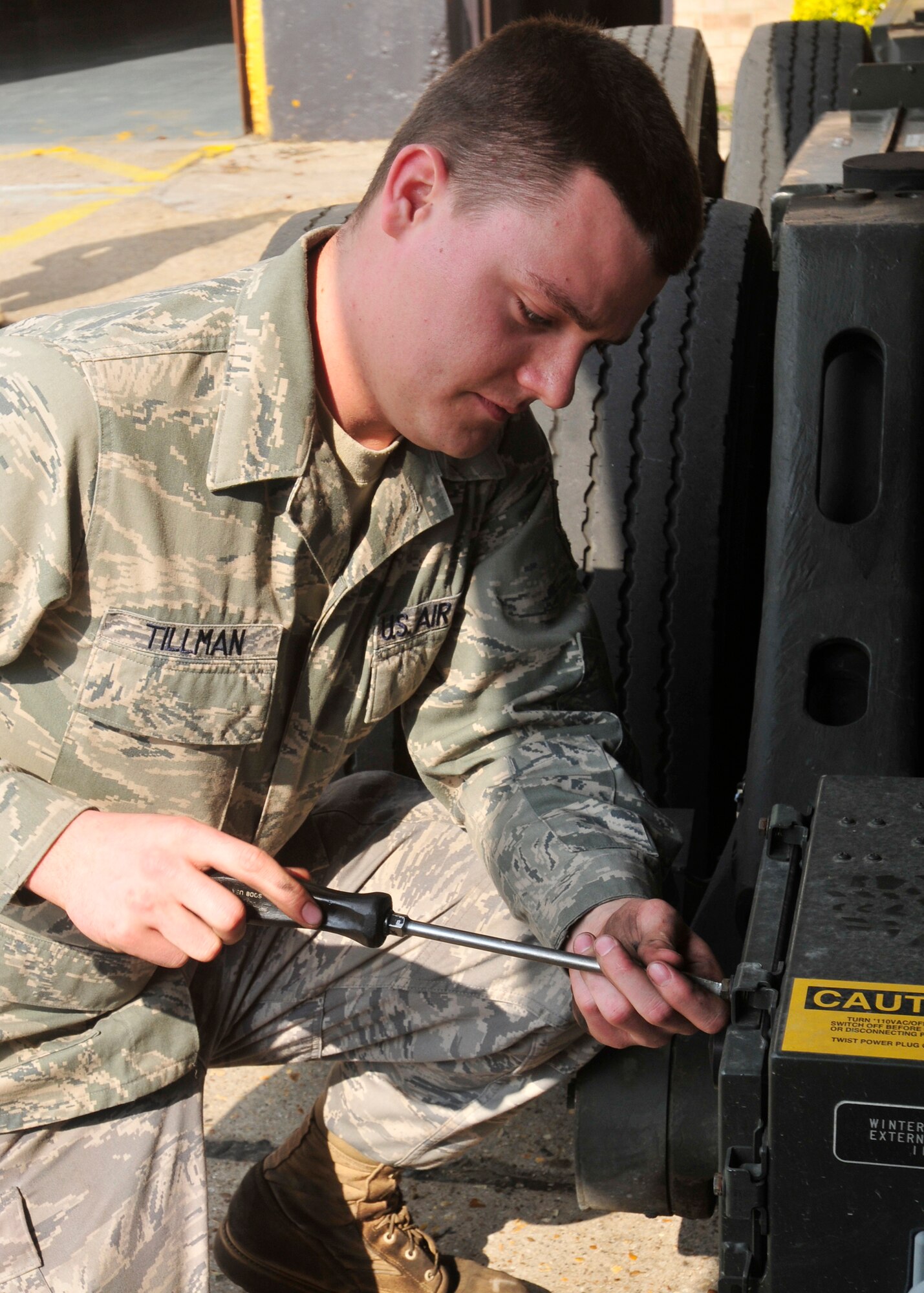 Senior Airman Trent Tillman, 48th Logistics Readiness Squadron vehicle maintenance and equipment journeyman, unscrews the A12 box to inspect the winterization electrical system on a 60K aircraft loader at RAF Lakenheath April 14. Airman Tillman was nominated for a liberty spotlight because he displays 'Service before Self'. (U.S. Air Force photo/A1C Tiffany Deuel)