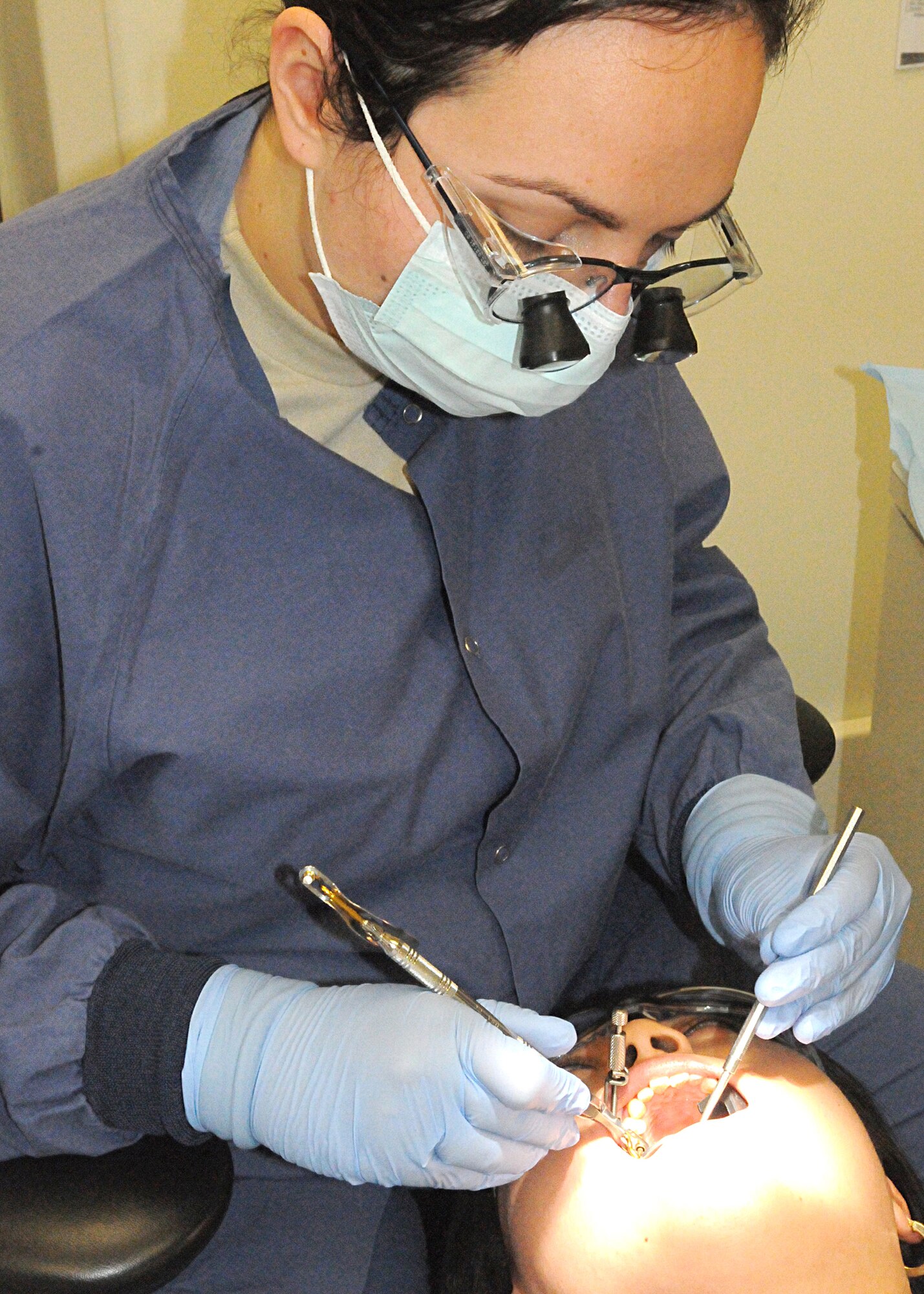 Capt. Susanna Gjekaj, 31st Dental Squadron dentist, checks a patient's teeth April 14 at the dental clinic. The 31st DS supports the readiness of the 31st Fighter Wing and associated units by providing optimal patient-focused dental care using internal, Department of Defense and host nation resources. (U.S. Air Force photo/Senior Airman Tabitha M. Mans)