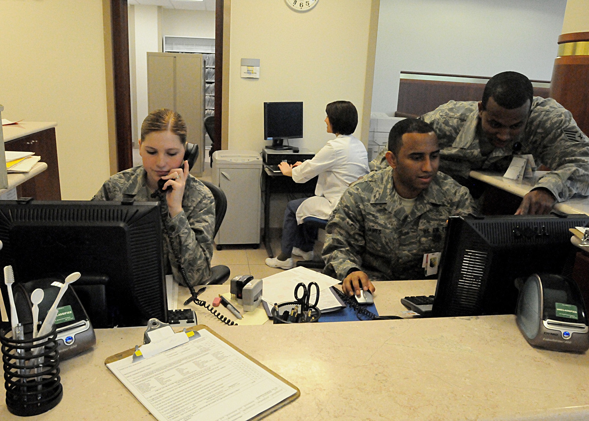 Technicians with the 31st Dental Squadron schedule and check in patients April 14 at the dental clinic front desk. The 31st DS integrates community-based preventive dental services and uses all dental resources to enable peak mission readiness and sustained performance. (U.S. Air Force photo/Senior Airman Tabitha M. Mans)