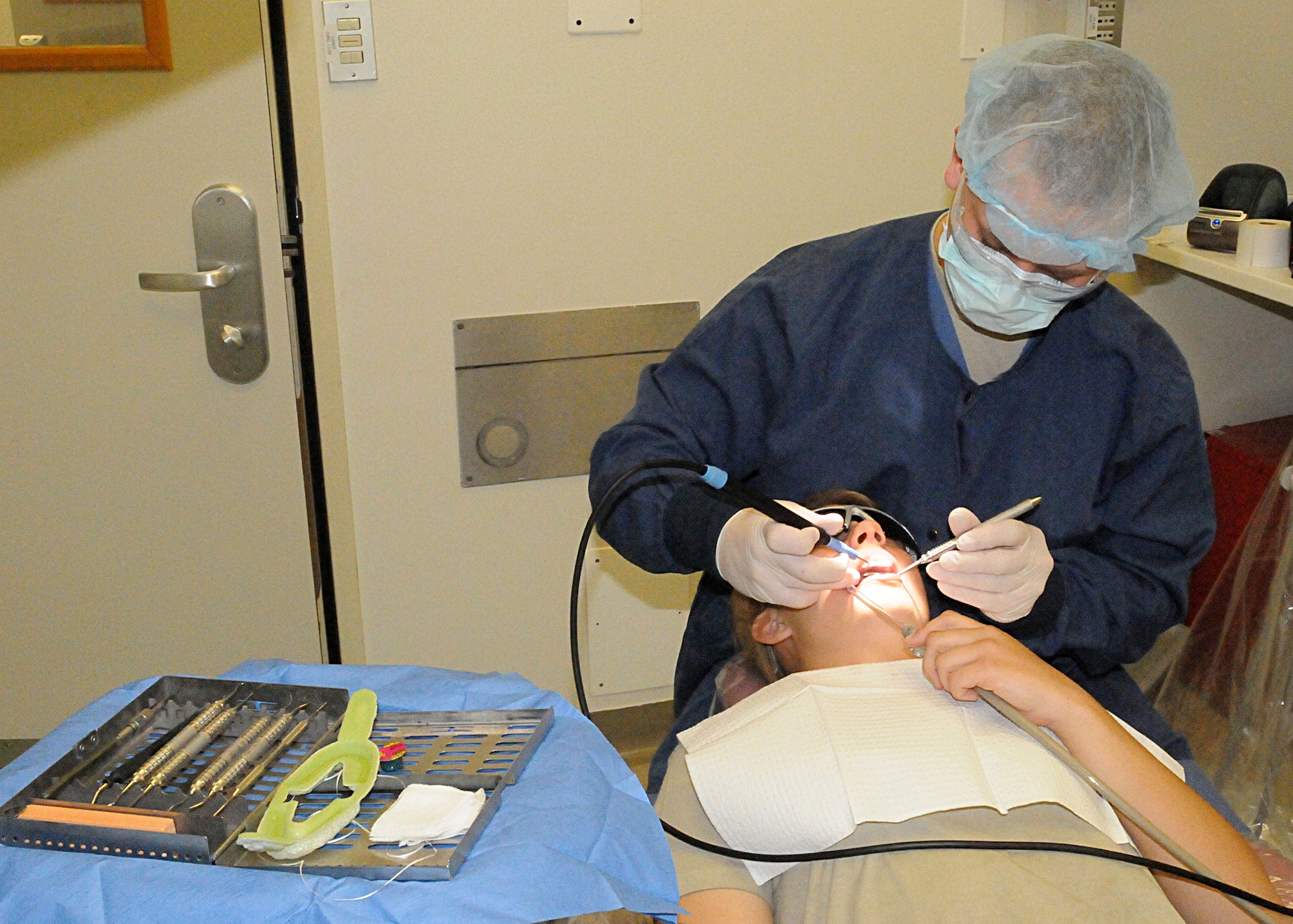 Airman 1st Class David Emert, 31st Dental Squadron dental technician, cleans the teeth of a patient April 14 at the dental clinic. Teeth cleaning is part of the annual physical heath assessment Airmen are required to complete at Aviano. (U.S. Air Force photo/Senior Airman Tabitha M. Mans)