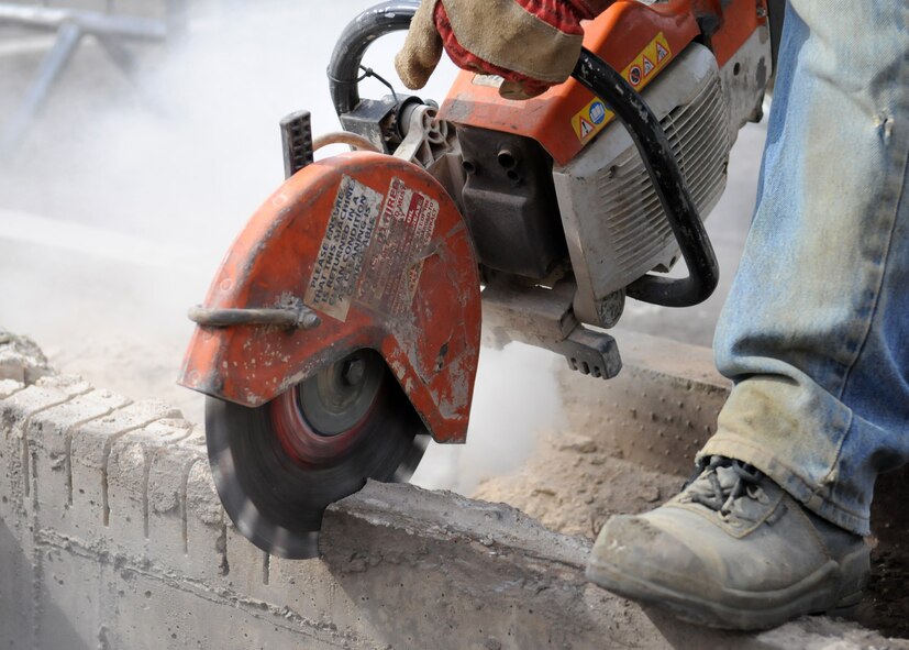 RAF MILDENHALL, England – A slab cutter slices through concrete with ease during the removal process to make room for a new sidewalk being built at the Galaxy Club parking lot April 14. (U.S. Air Force photo/ Staff Sgt. Jerry Fleshman)