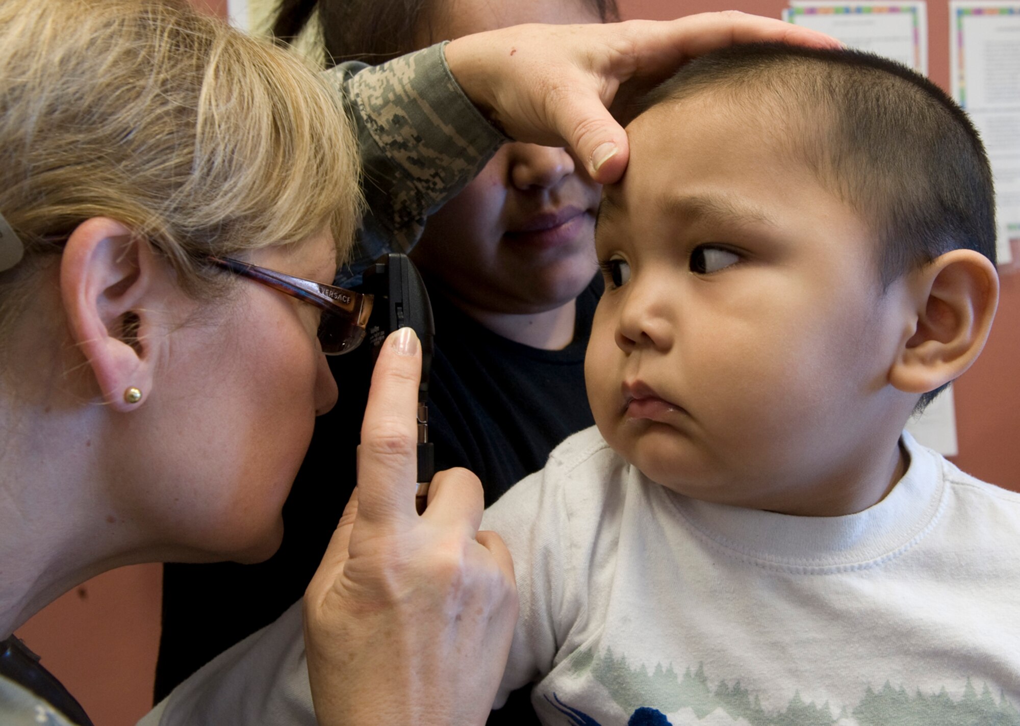 Maj. Emily Cerreta checks 23-month-old Hikerr Snyder's eyes during his well-baby checkup April 14, 2010, in Noorvik, Alaska. Major Cerreta is a family nurse practitioner from the 433rd Airlift Wing at Lackland Air Force Base, Texas, and is in Alaska for Operation Arctic Care, a joint medical training exercise.  (U.S. Air Force photo/Master Sgt. Jack Braden)