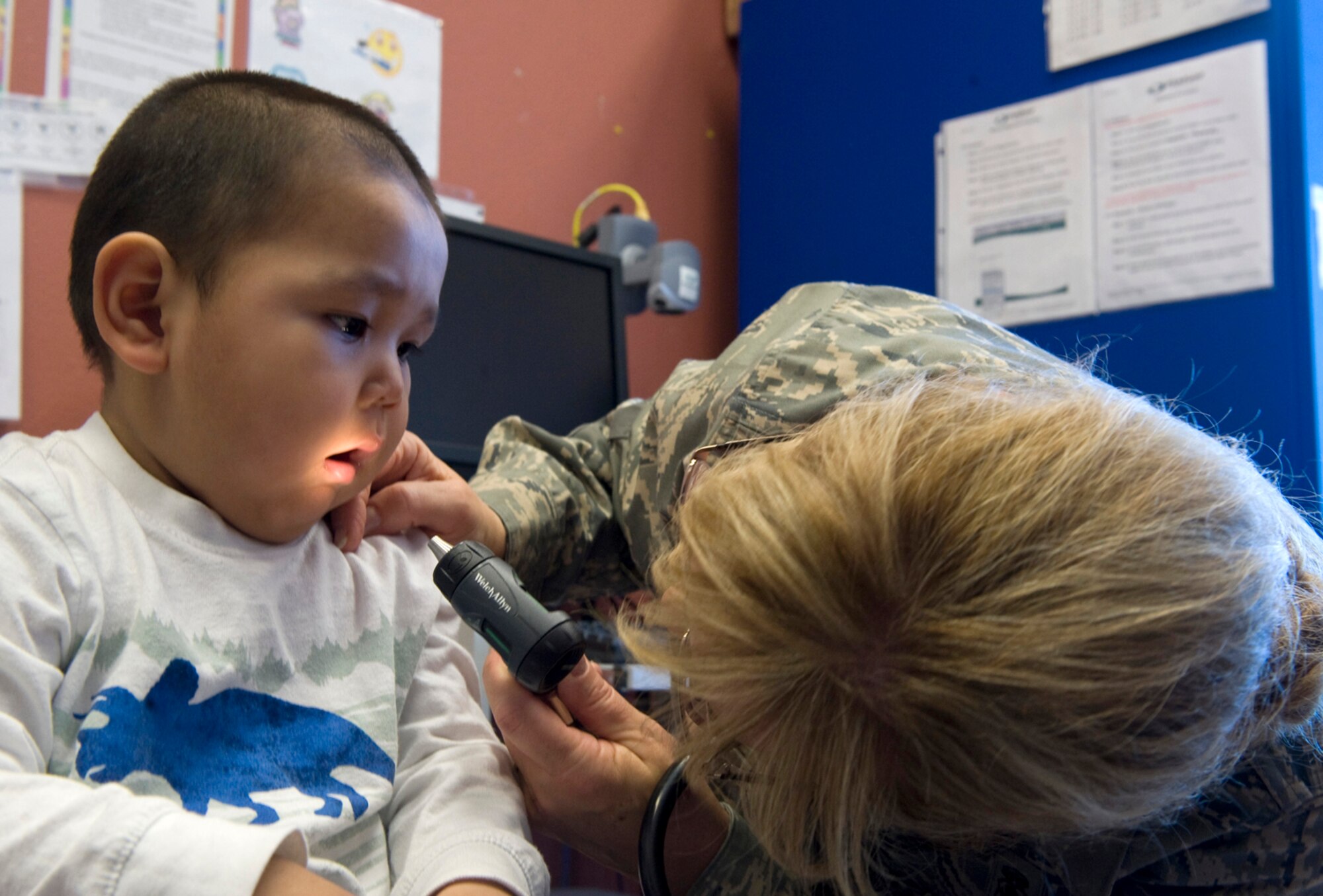 Maj. Emily Cerreta checks the teeth and gums of 23-month-old Hikerr Snyder during his well-baby checkup April 14, 2010, in Noorvik, Alaska.  Major Cerreta is a family nurse practitioner from the 433rd Airlift Wing at Lackland Air Force Base, Texas, and is in Alaska for Operation Arctic Care, a joint medical training exercise.  (U.S. Air Force photo/Master Sgt. Jack Braden)