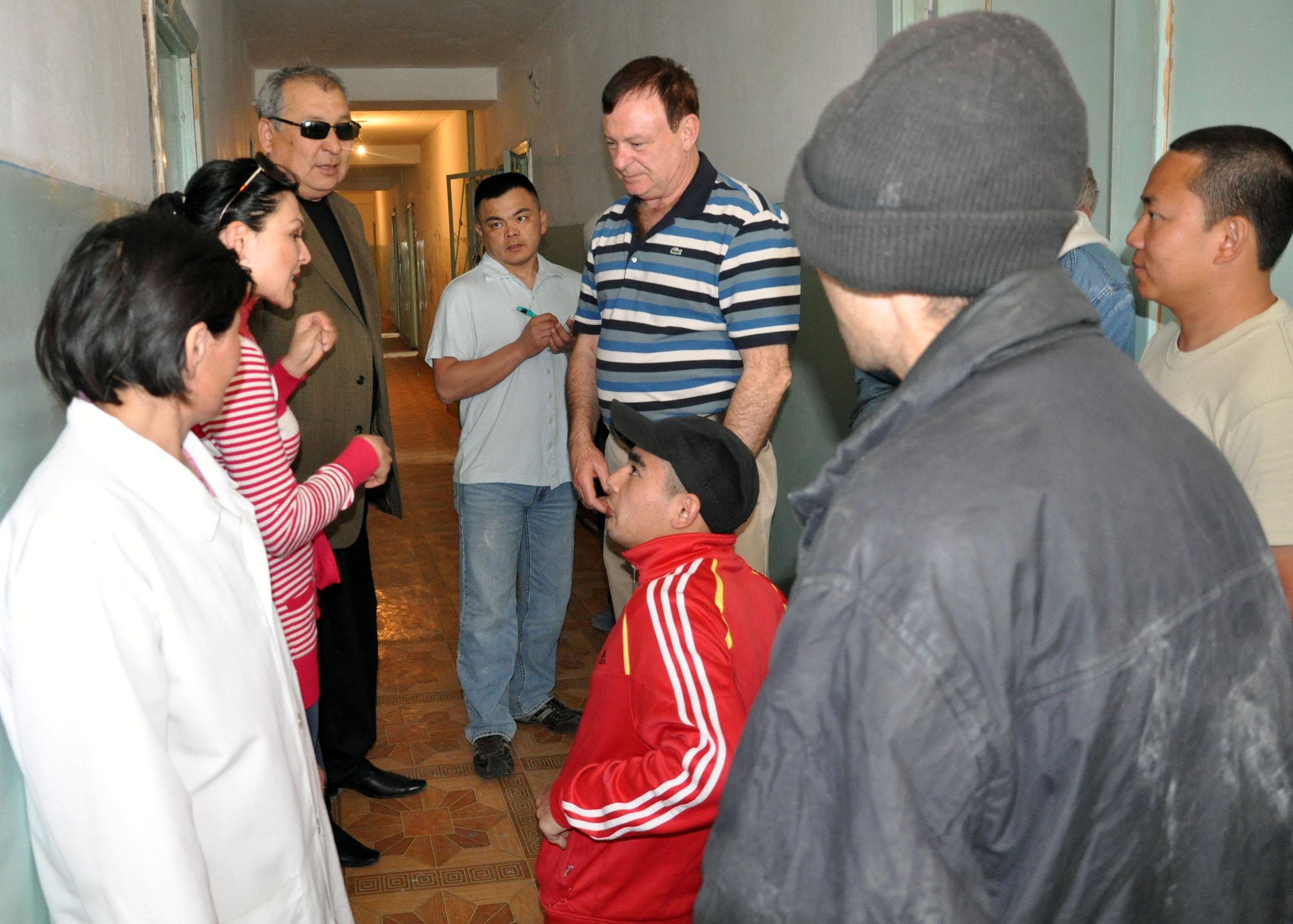 Airmen from the Transit Center at Manas, Kyrgyzstan, talk to patients and a staff member of the Psychoneurologic Boarding House in Iskra Village, Kyrgyzstan, April 14, 2010, through the help of a translator. Airmen from the Transit Center visited to bring food, clothing, and some entertainment items and to see how they can help the boarding house in the future. (U.S. Air Force photo/Staff Sgt. Carolyn Viss)
