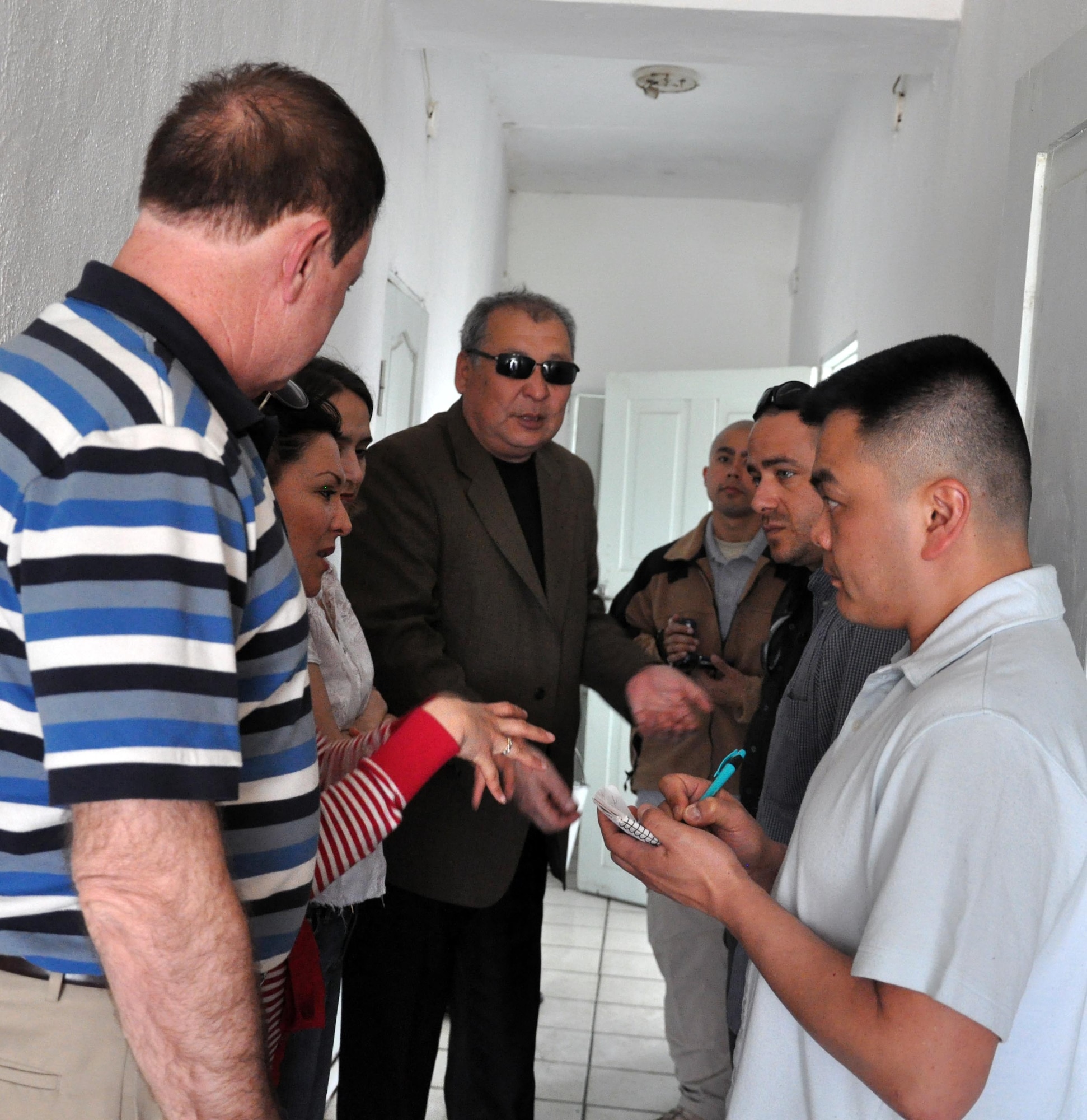 U.S. Air Force Capt. Tom Mulka (right), the Manas Area Benefit Outreach Society president, writes down some things the director of the TokMok Psychoneurologic Boarding House said they need during a humanitarian assistance visit April 14, 2010, in Iskra Village, Kyrgyzstan. This boarding house hosts 255 male patients and is badly in need of repair and basic amenities. Airmen from the Transit Center at Manas visited to bring food, clothing, and some entertainment items and to see how they can help the boarding house in the future. (U.S. Air Force photo/Staff Sgt. Carolyn Viss)