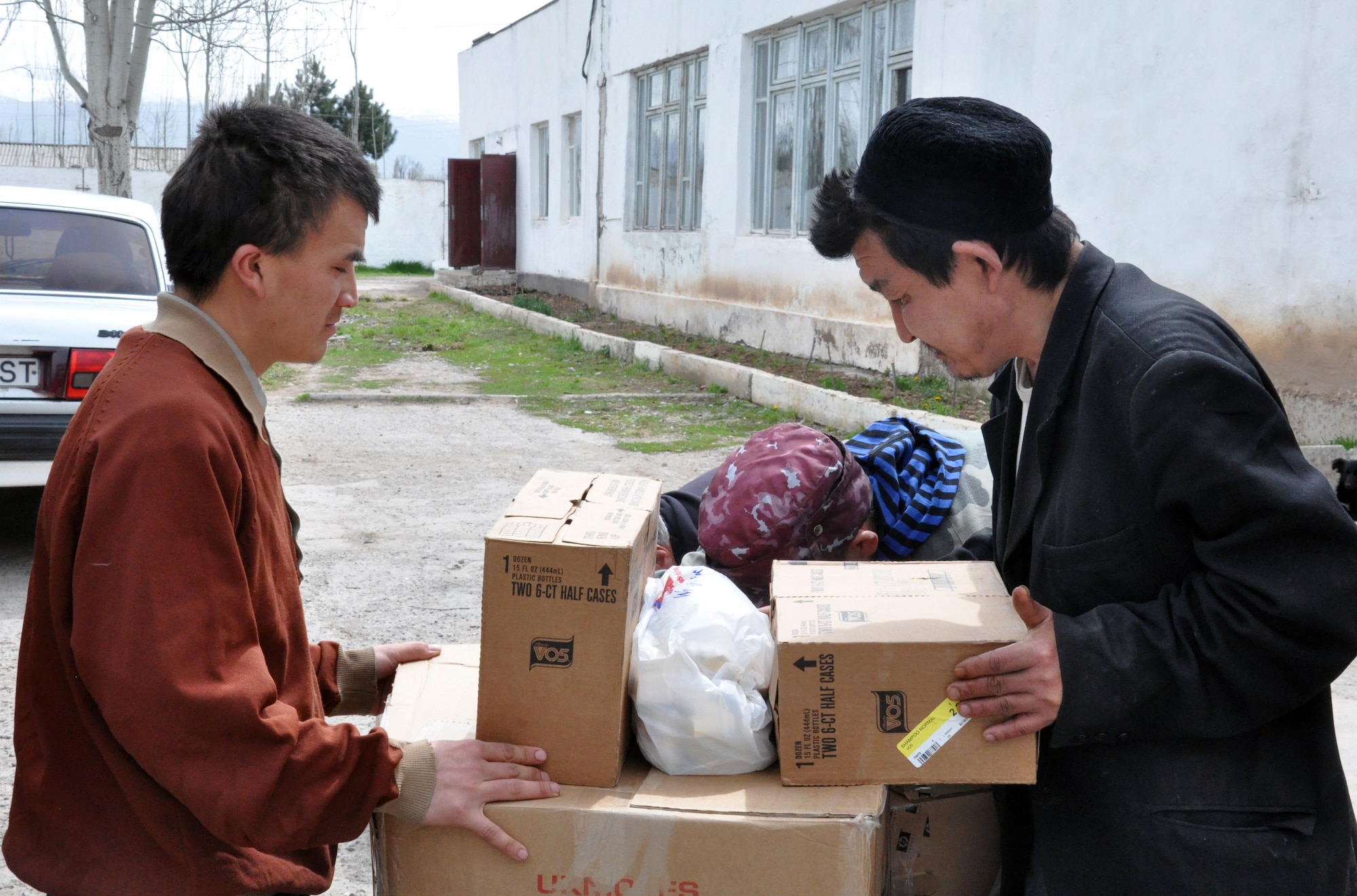 Residents of the TokMok Psychoneurologic Boarding House in Iskra Village, Kyrgyzstan, check out what the Airmen from the Transit Center at Manas brought during a humanitarian assistance visit April 14, 2010. This boarding house hosts 255 male patients and is badly in need of repair and basic amenities. Airmen from the Transit Center at Manas visited to bring food, clothing, and some entertainment items and to see how they can help the boarding house in the future. (U.S. Air Force photo/Staff Sgt. Carolyn Viss)