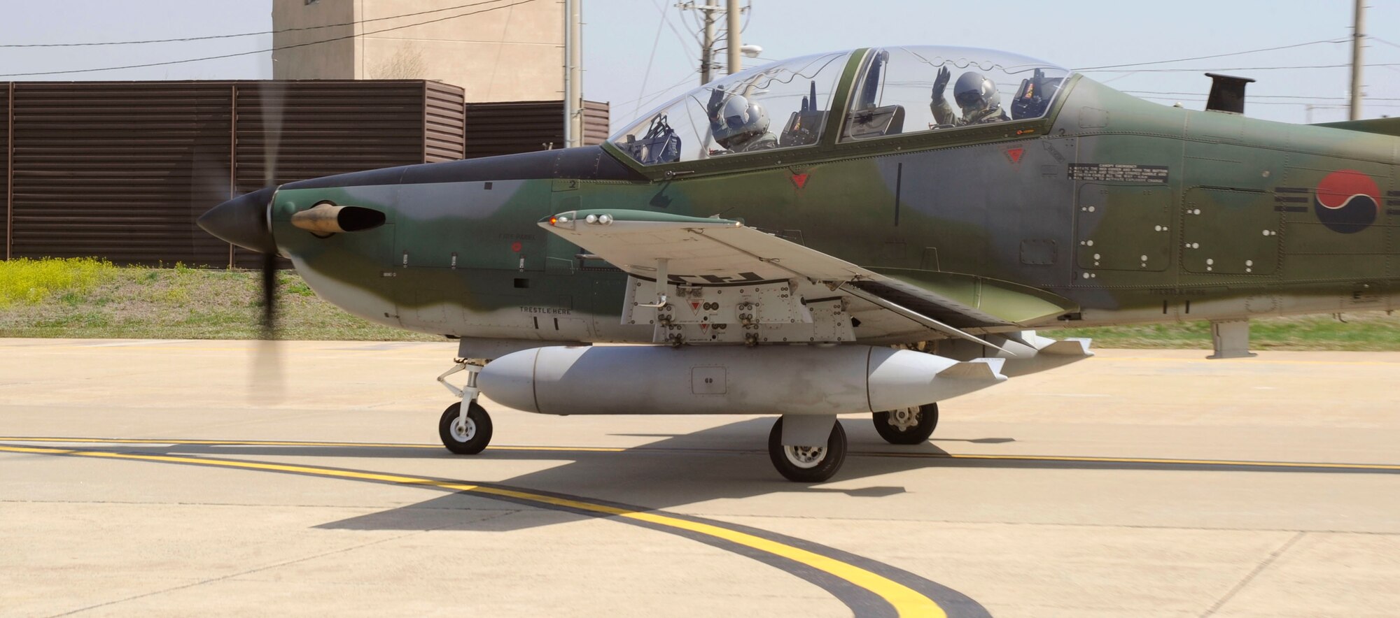 Maj. Jwa-Ryong Park and his co-pilot wave as they prepare to take off in a KA-1 aircraft April 15 at Osan Air Base, Republic of Korea. Major Park is the 237th Tactical Fighter Squadron intelligence commander from Seoul, ROK. Major Park and 237th TFS members are here participating in Buddy Wing, a joint, bi-yearly training exercise involving the ROK Air Force and the U.S. Air Force. (U.S. Air Force photo/Staff Sgt. Stephenie Wade)