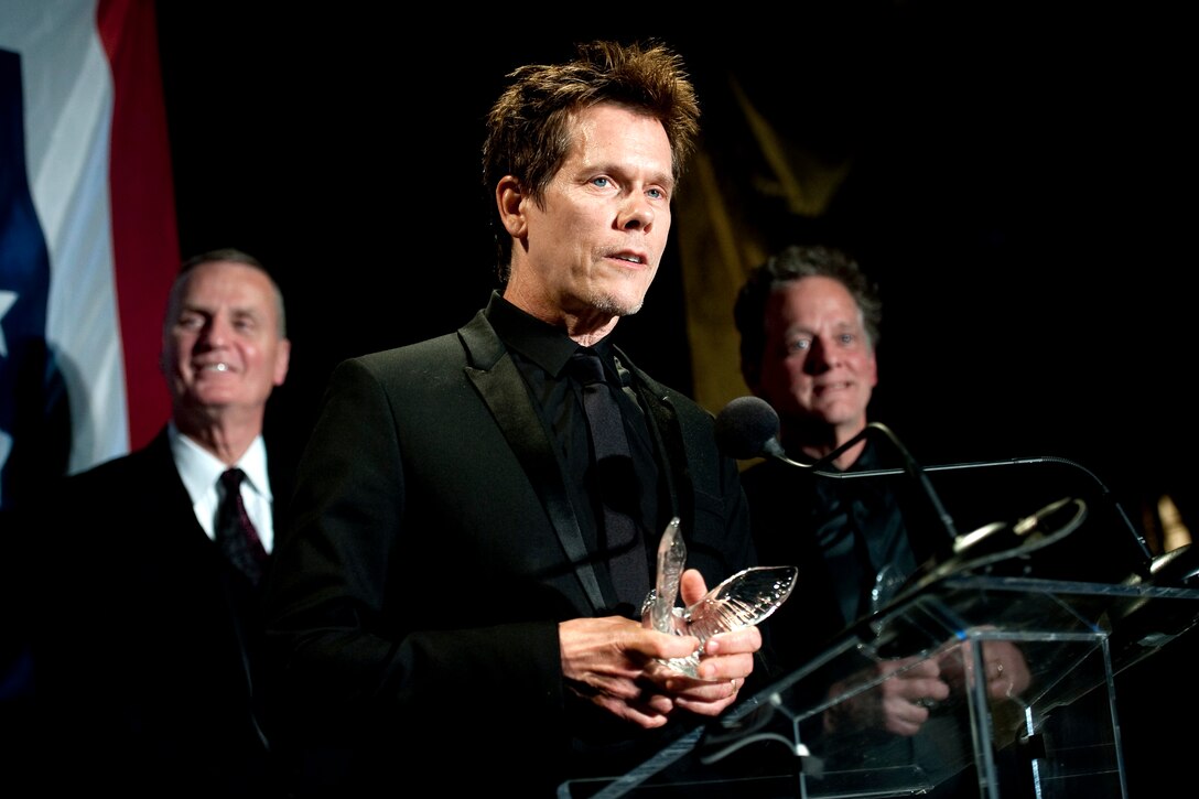 Actor Kevin Bacon addresses the audience after he received the Merit Service Award at the annual USO Gala in Arlington, Va., April 14, 2010. His brother, musician Michael Bacon, received the same award.
