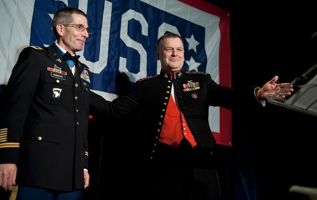 Marine Corps Gen. James E. Cartwright, vice chairman of the Joint Chiefs of Staff, congratulates Col. Gordon R. Roberts after presenting him with the Col. John Gioia Patriot Award at the annual USO Gala in Arlington, Va., April 14, 2010.