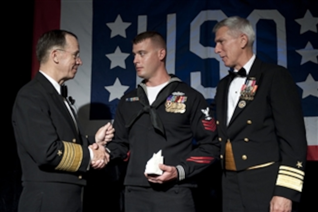 Chairman of the Joint Chiefs of Staff Adm. Mike Mullen and the Director of Navy Staff Vice Adm. Samuel Locklear congratulate Petty Officer 1st Class David J. Brown after presenting him with the Special Salute Award at the annual USO Gala at the Ritz Carlton in Arlington, Va., on April 14, 2010.  