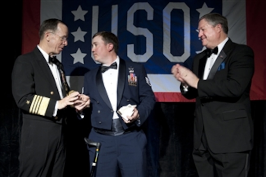 Chairman of the Joint Chiefs of Staff Adm. Mike Mullen and Secretary of the Air Force Michael Donley present Staff Sgt. David Flowers with the Special Salute Award at the annual USO Gala at the Ritz Carlton in Arlington, Va., on April 14, 2010.  