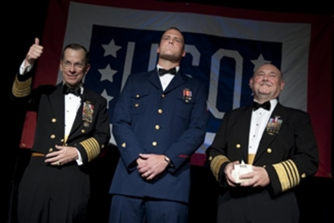 Chairman of the Joint Chiefs of Staff Adm. Mike Mullen and Commandant of the Coast Guard Adm. Thad Allen present Petty Officer 2nd Class Justin J. Monk with the Special Salute Award at the annual USO Gala at the Ritz Carlton in Arlington, Va., on April 14, 2010.  