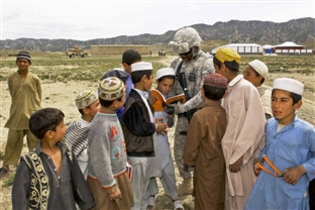 U.S. Army Sgt. Terrance Ray reads a book to children while on a mission in Orgun, Paktika province, Afghanistan, April 11, 2010. Ray is a member of the security force element for the Paktika Provincial Reconstruction Team’s Orgun detachment. The team's mission is to help legitimize the government of Afghanistan through development, governance and agricultural initiatives. Ray is assigned to 1st Battalion, 178rd Field Artillery Regiment, South Carolina National Guard.    