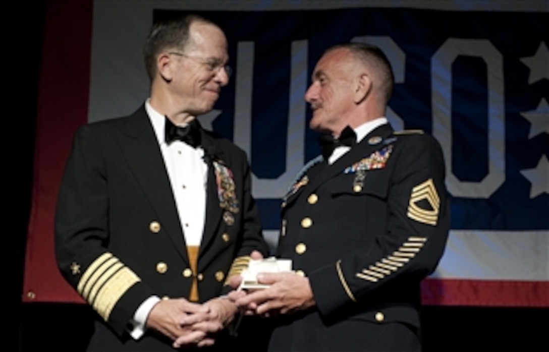Chairman of the Joint Chiefs of Staff Adm. Mike Mullen congratulates U.S. Army Master Sgt. Robert Sutherland after presenting him with the Special Salute Award at the annual USO Gala at the Ritz Carlton in Arlington, Va., on April 14, 2010.  