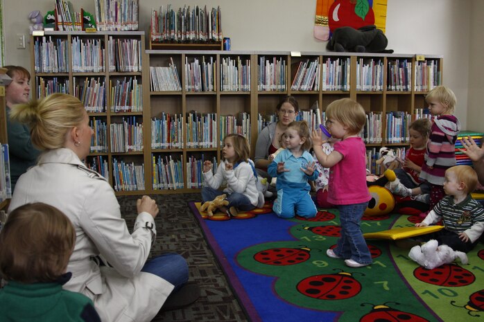 Parents and children gather for Story Time at the station library here April 15. Story Time is a chance for children to interact with one another and is offered every Thursday at the station library between 10 and 11 a.m.