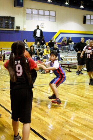 A Sixers player tries to inbound the ball during the youth basketball 10- to 12-year-old division championship game at IronWorks Gym here April 15. The Knicks defeated the Sixers 22-14 and were named season champions.