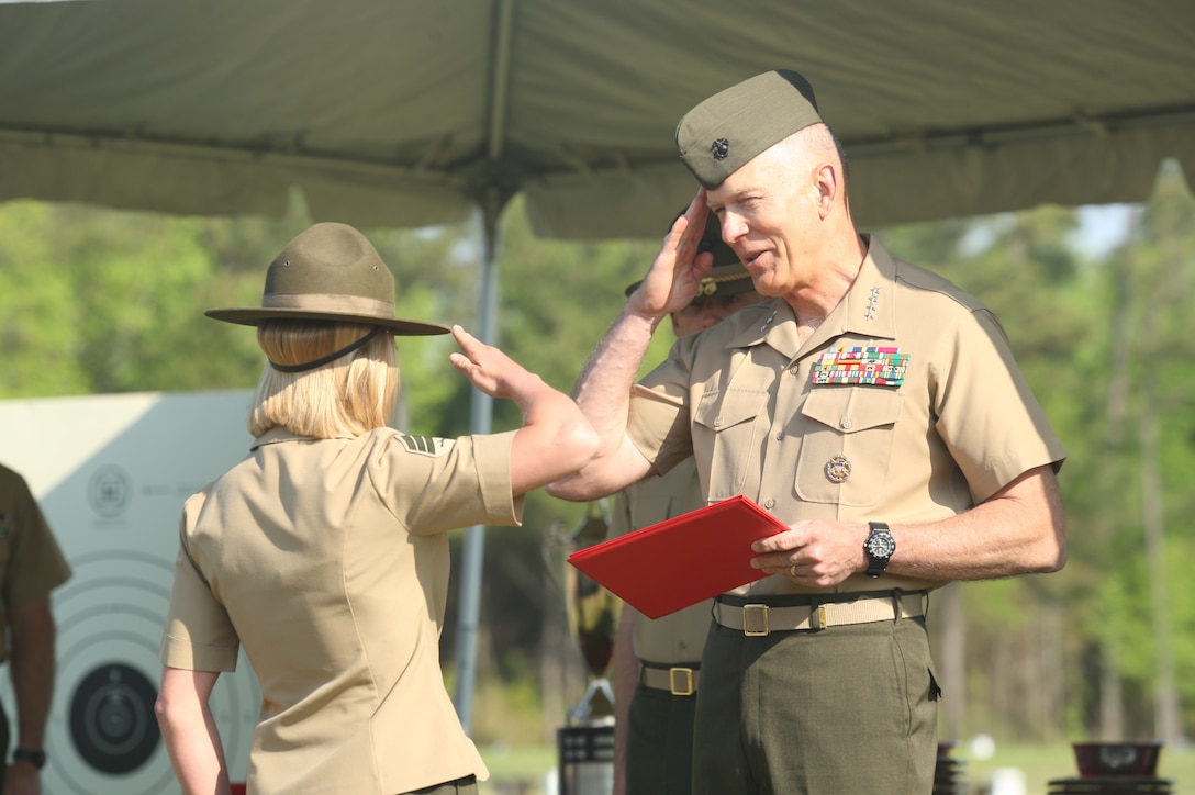 Sgt. Emily Windmassinger, left, a member of the Marine Corps Shooting Team, salutes Gen. James T. Conway, commandant of the Marine Corps, before receiving a distinguished certificate during the Competition-In-Arms Program Marine Corps Matches awards ceremony, April 16. The Marine Corps match is the final round in the CIAP’s three-part Marine Corps-wide marksmanship competition.