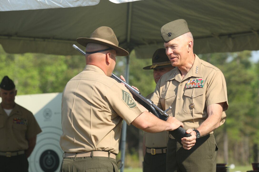 Gunnery Sgt. James Otto, left, a member of the Marine Corps Shooting Team, receives an award rifle from Gen. James T. Conway, Commandant of the Marine Corps, during the Competition-In-Arms Program Marine Corps Matches awards ceremony, April 16. Otto placed first in the individual rifle portion of the Marine Corps match, making him the best rifle marksman in the Marine Corps.