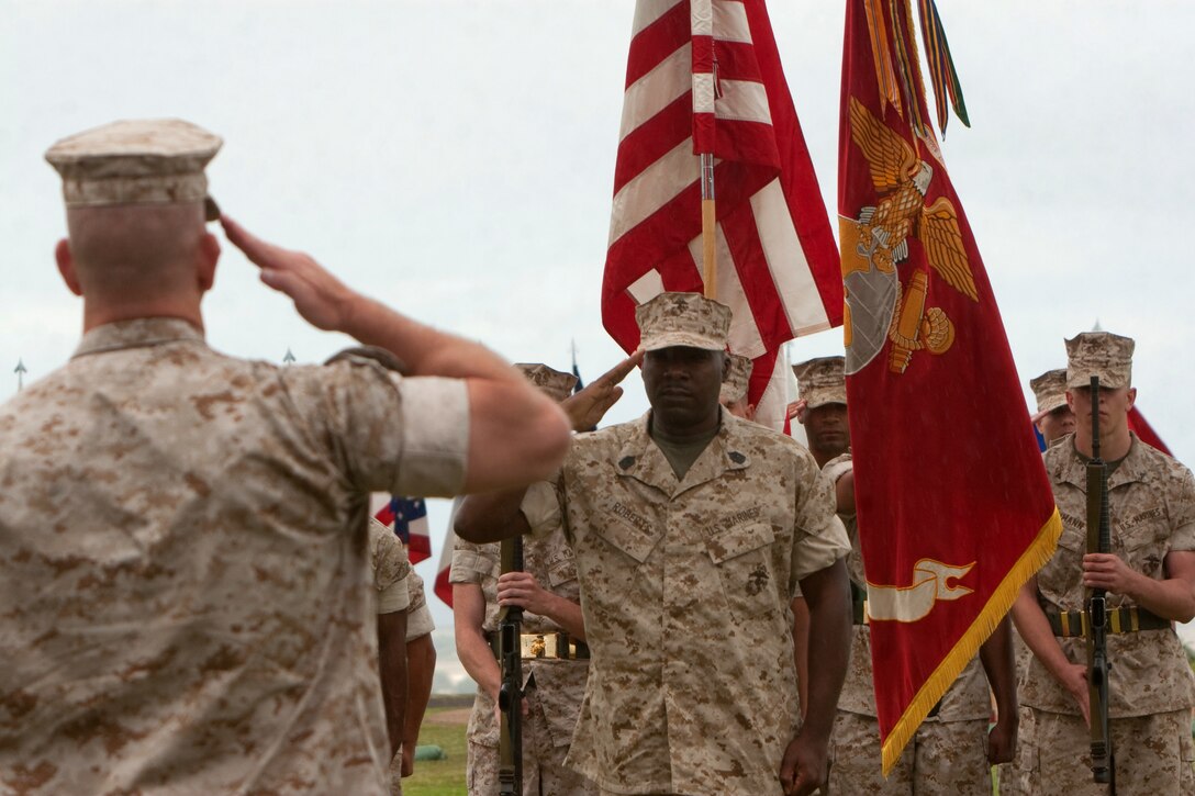 Sergeant Maj. James Roberts Jr., former Headquarters and Service Battalion, U.S. Marine Corps Forces, Pacific, sergeant major, reports to Col. Alan L. Thoma, H&S Bn. commander, during his retirement ceremony April 16 at Bordelon Field, Camp H. M. Smith, Hawaii. Roberts passed his position as battalion sergeant major to Sgt. Maj. Scott M. Smith prior to his retirement.