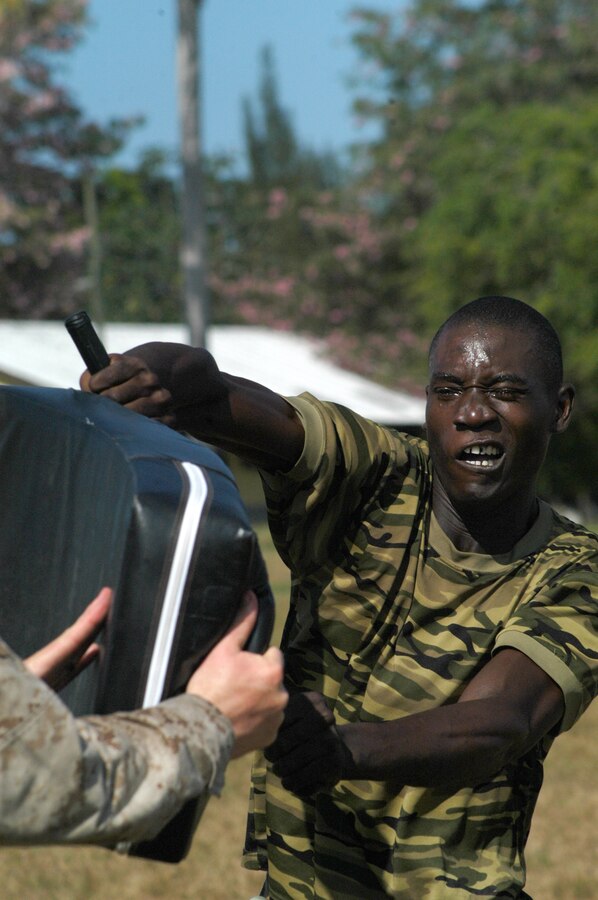 Royal Suriname Defense Force Pfc. Miguel Doorson, an infantryman with 33rd Infantry Battalion, strikes a training pad while oleoresin capsicum spray produces an extreme burning sensation on his face during a week-long non-lethal weapons course led by Marines from Military Police Co. A, from Lexington, KY. The training is part of Tradewinds 2010,  a Chairman of the Joint Chiefs directed, U.S. Southern Command sponsored annual exercise that is conducted with Caribbean Basin Partner Nations, designed to improve cooperation with the partner nations in responding to regional security threats. (Official USMC photo by Lance Cpl. Lucas Vega)