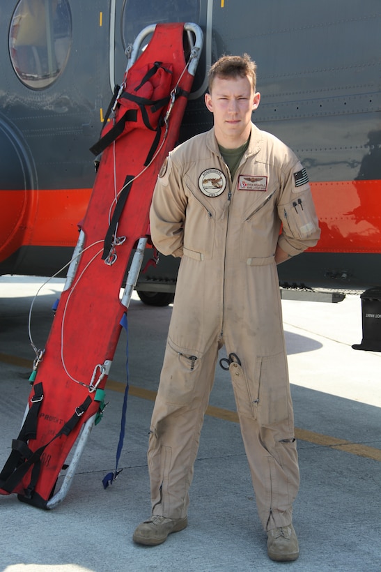 Petty Officer 2nd Class Ryan E. Honnoll, a Search and rescue medical technician with Marine Transport Squadron 1, poses with a strecher that is carried on the HH-46E Super Stallion.