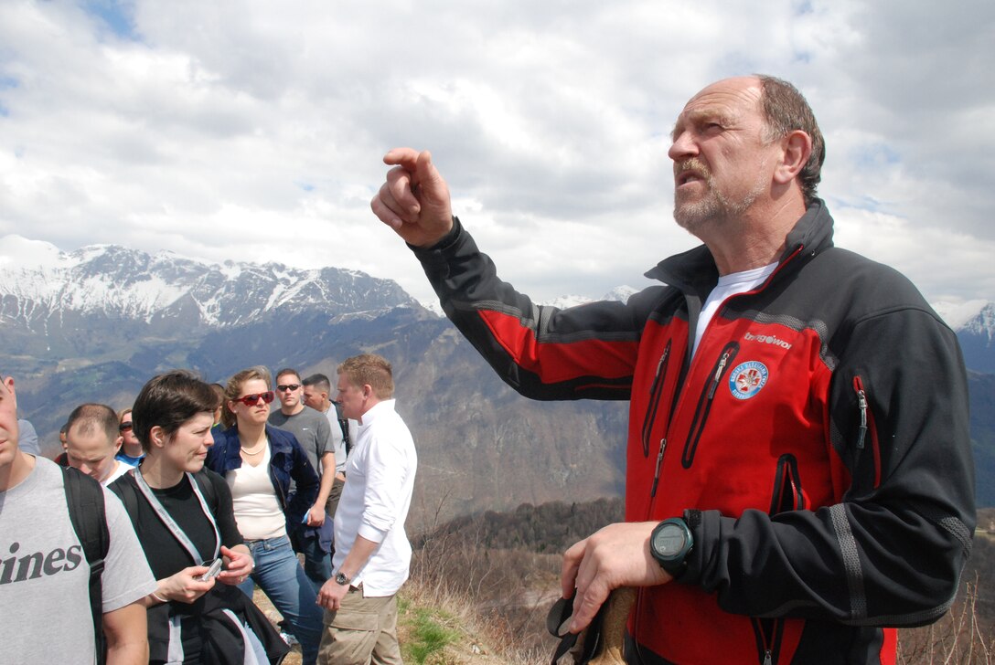 Personnel and family members with U.S. Marine Forces Europe and U.S. Marine Forces Africa pause during a guided discussion on a ridgeline overlooking the Soca Valley in Slovinia during a recent period of military education.  During the two-day event, the group visited a local museum, and completed a walk along German Lt. Erwin Rommel’s famed attack route.  The walk included a guided discussion along the 10-kilometer route, as well as a visit to an outdoor museum, where original Italian trenches and bunkers still exist.