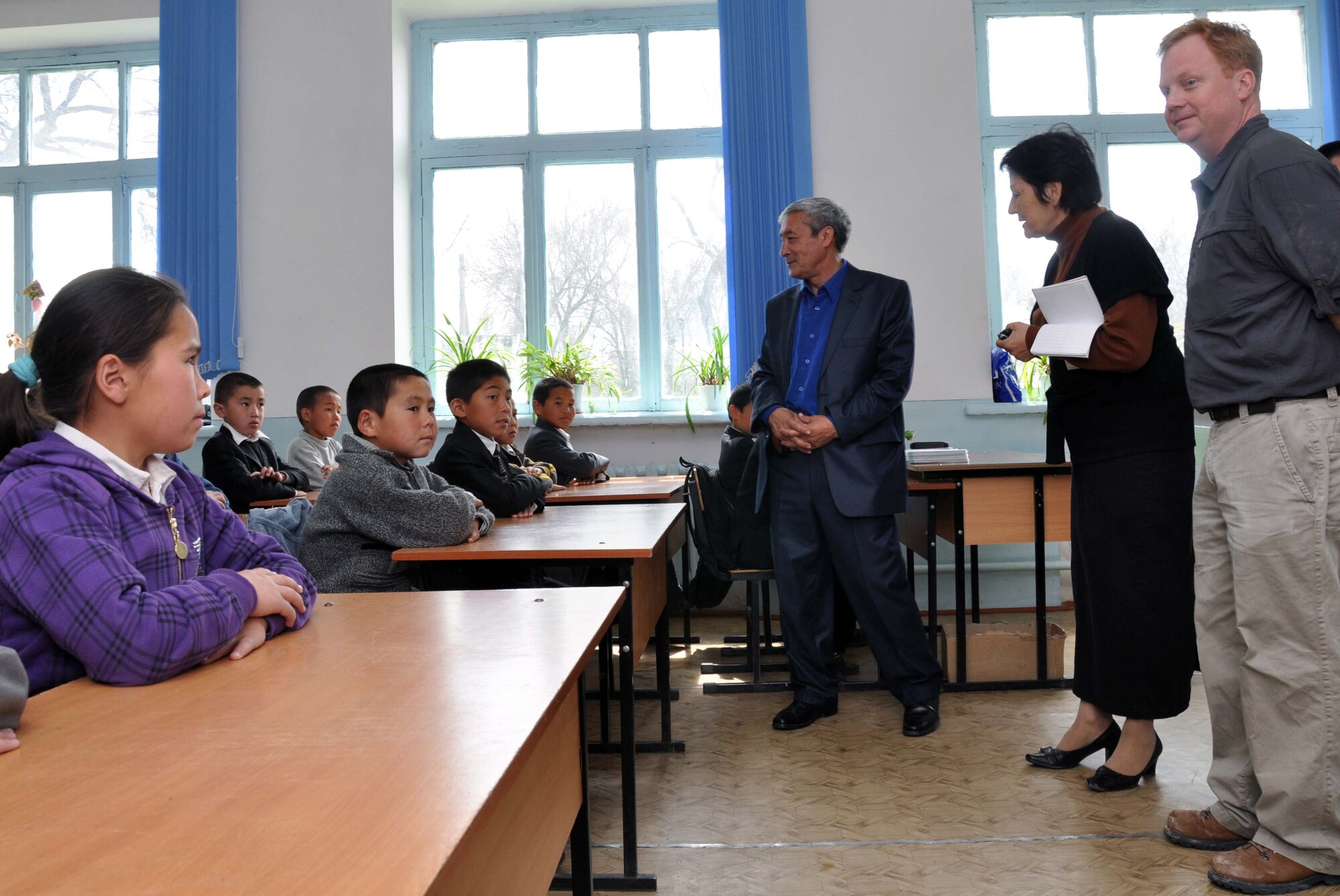 U.S. Air Force Lt. Col. Neal Linch, the Transit Center at Manas humanitarian assistance director, right, visits with children at the Panfilovskaya Boarding School/Orphanage, Kyrgyzstan, April 16, 2010. Airmen visited to deliver food and see what the school needs. Hosting 250 children ages 6 to 18, the school needs sponsors to help improve facilities and education. (U.S. Air Force photo/Staff Sgt. Carolyn Viss)