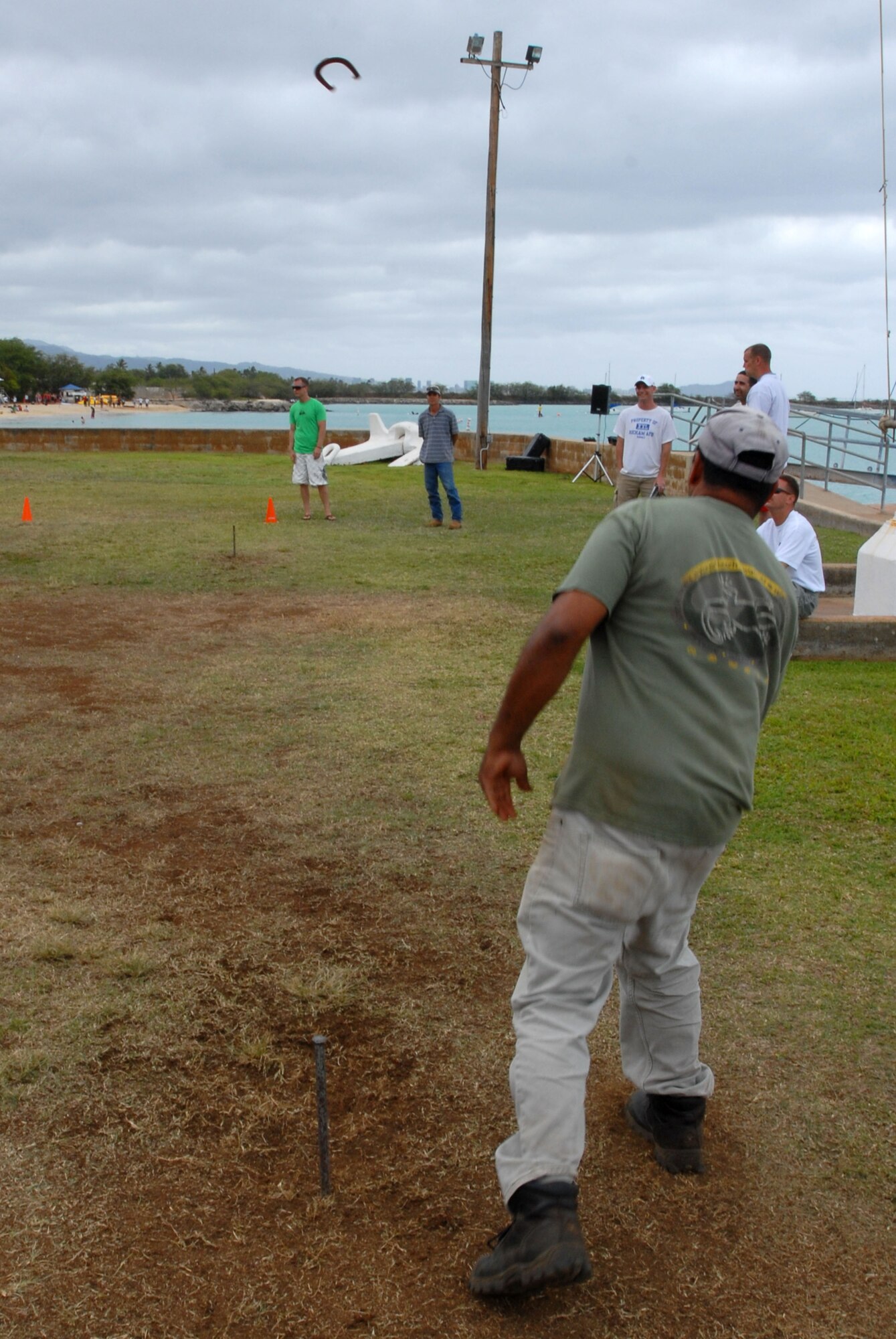 JOINT BASE PEARL HARBOR HICKAM, Hawaii – David Silva, 15th Civil Engineer Squadron, takes aim at the post in a game of Horseshoe during the Team Hickam Sports Day here, April 16. (U.S. Air Force photo/Senior Airman Gustavo Gonzalez)