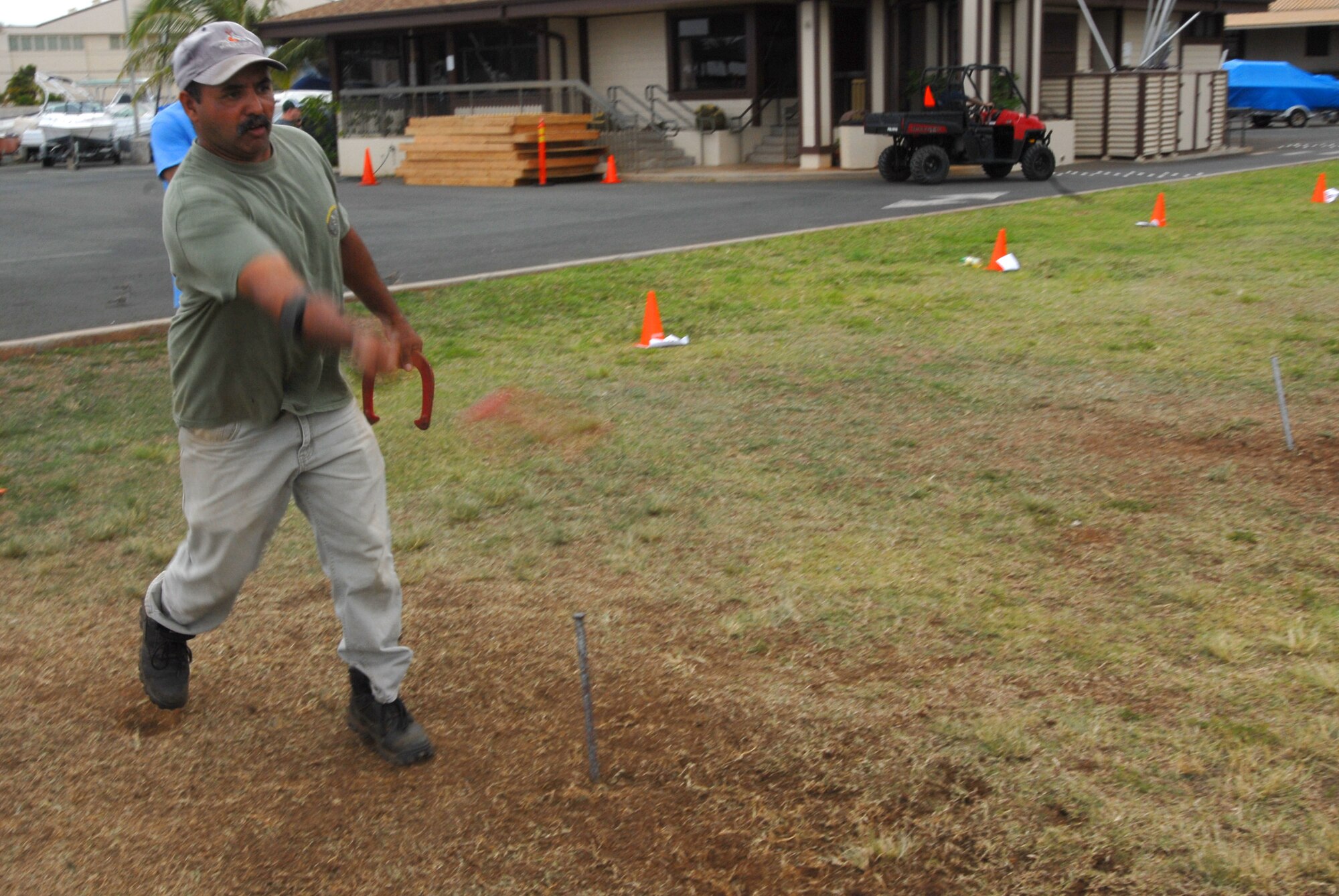 JOINT BASE PEARL HARBOR HICKAM, Hawaii – David Silva, 15th Civil Engineer Squadron, takes aim at the post in a game of Horseshoe during the Team Hickam Sports Day here, April 16. (U.S. Air Force photo/Senior Airman Gustavo Gonzalez)