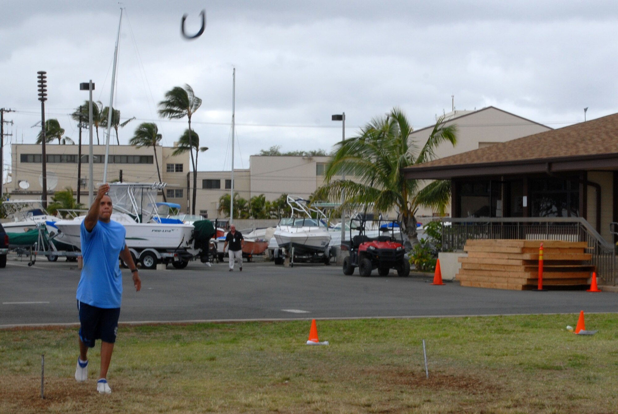 JOINT BASE PEARL HARBOR HICKAM, Hawaii – Tech. Sgt. Marcus Nelson, 735th Aircraft Maintenance Squadron, takes aim at the post in a game of Horseshoe during the Team Hickam Sports Day here, April 16. (U.S. Air Force photo/Senior Airman Gustavo Gonzalez)